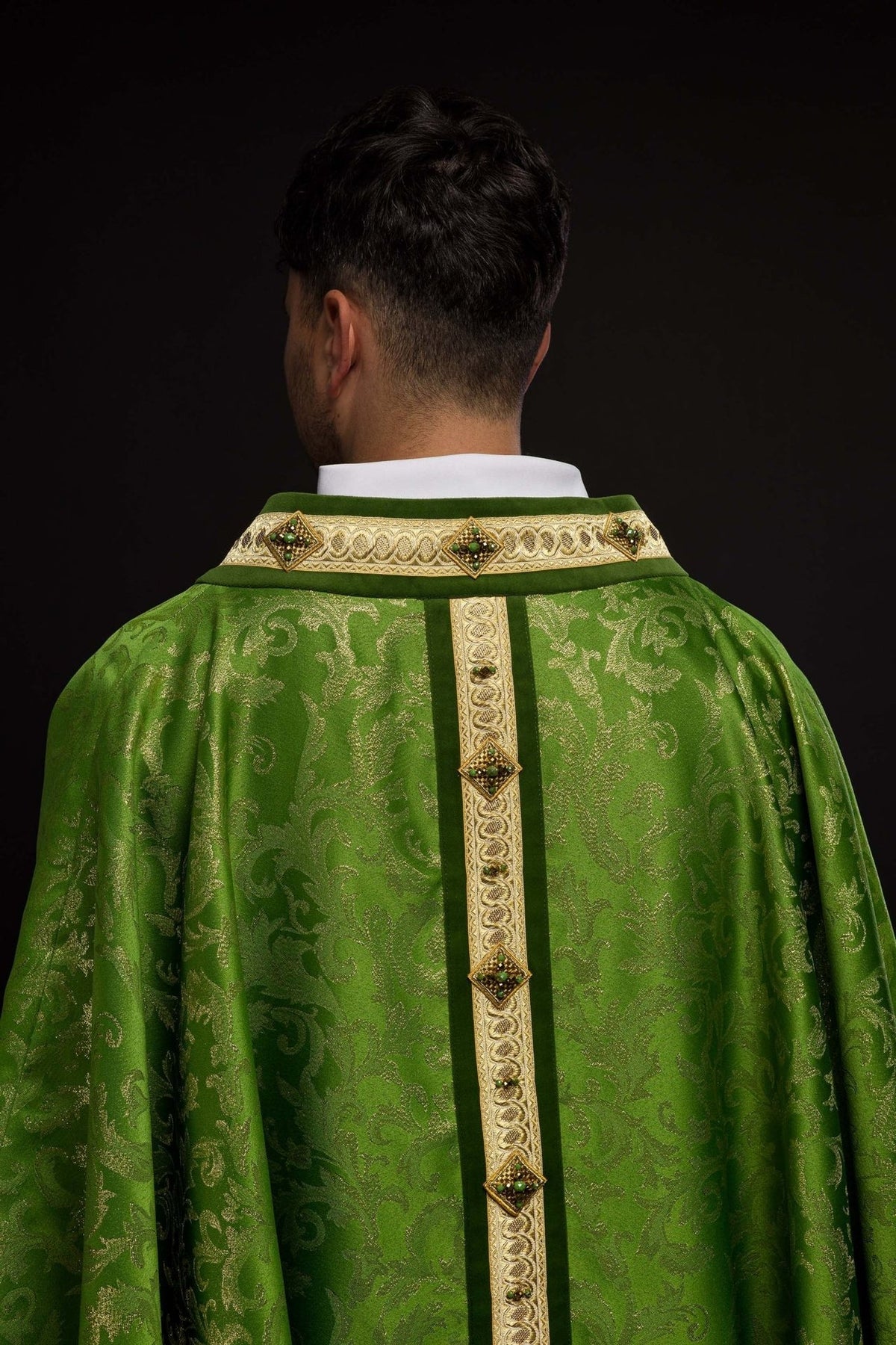 Green chasuble back view with gold orphrey and natural stone details