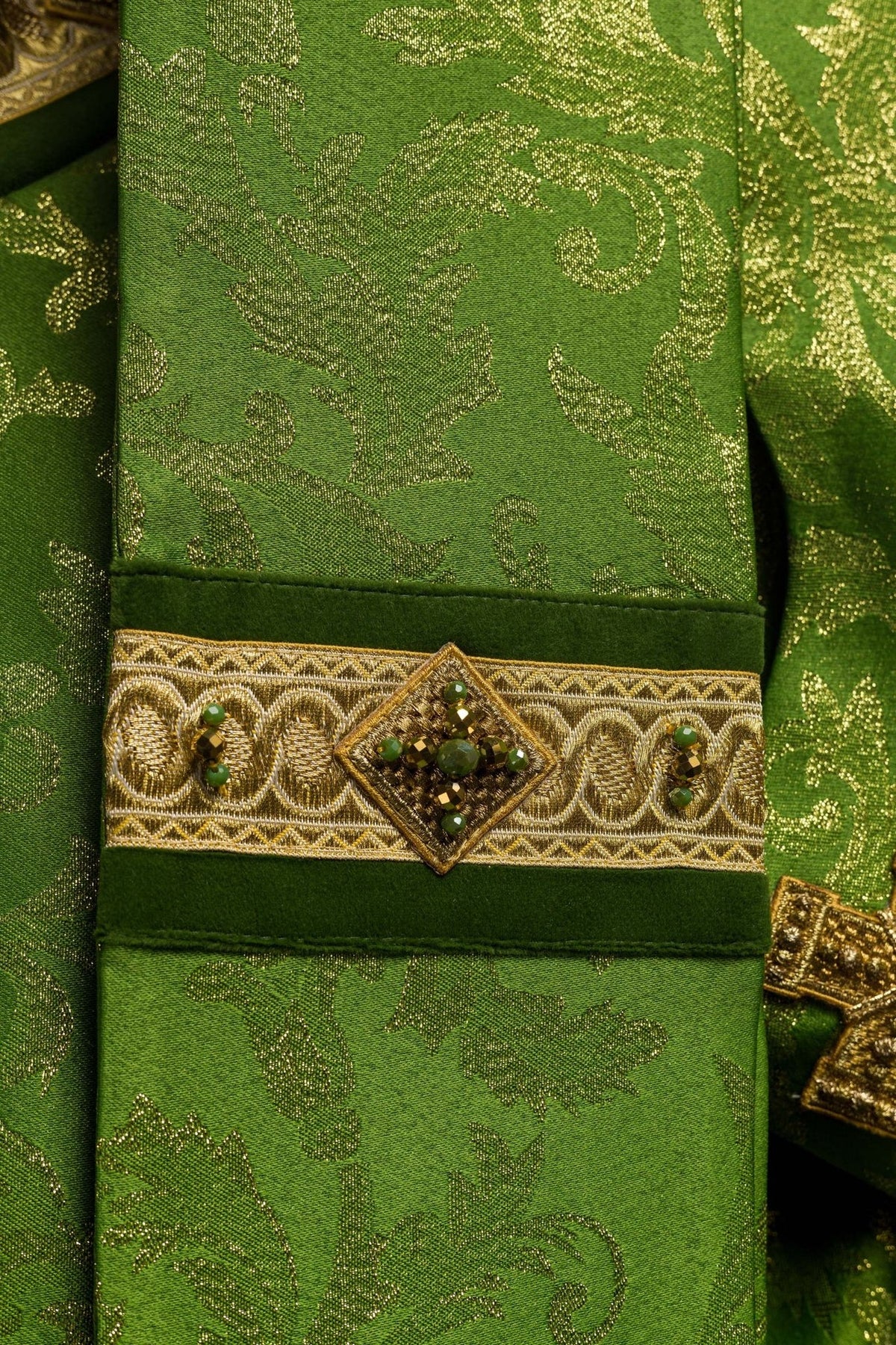 Green chasuble close-up of sleeve gold embroidery and jacquard pattern