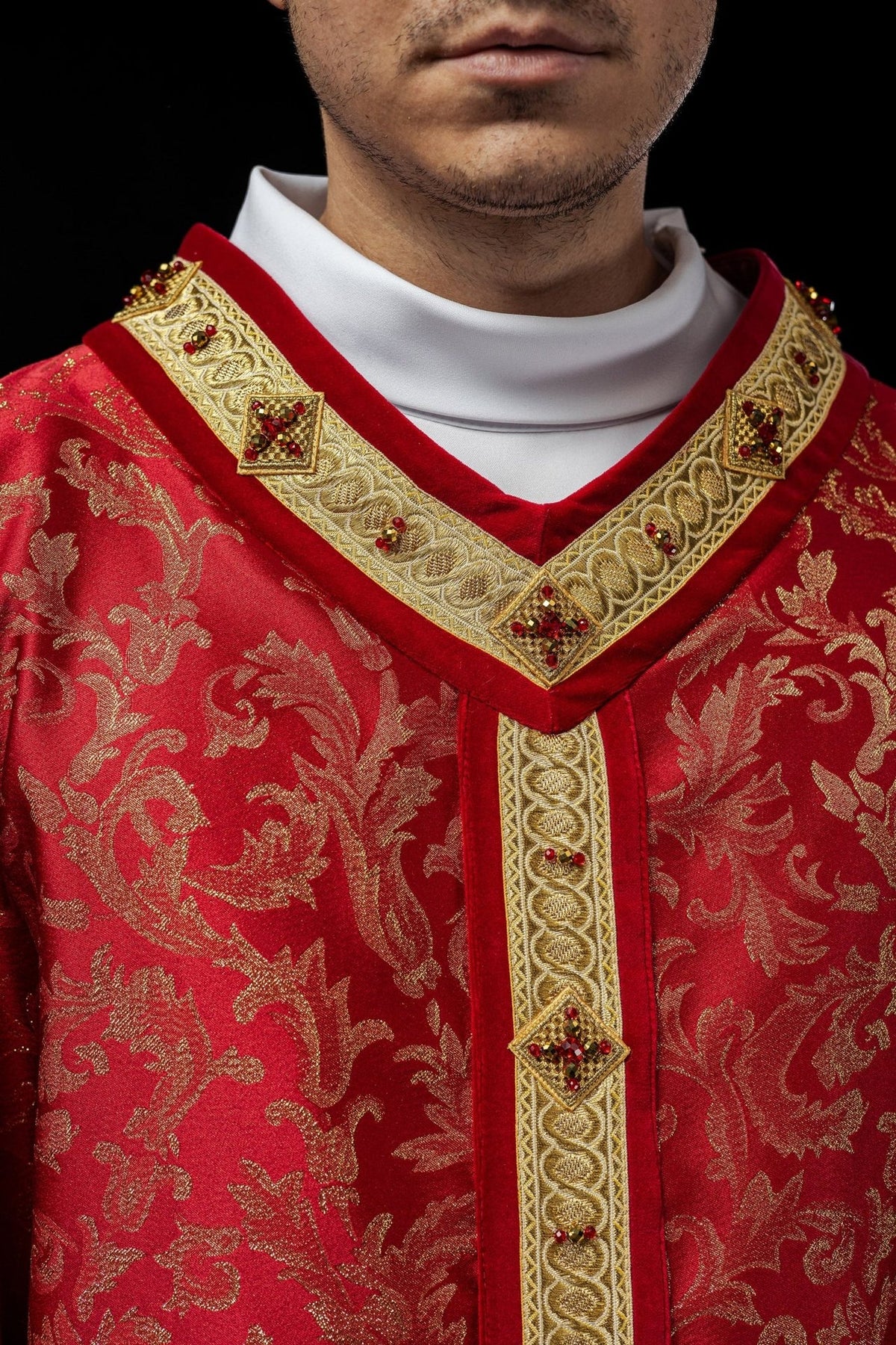 Handcrafted chasuble close-up of red neckline with gold orphrey and natural stone embroidery