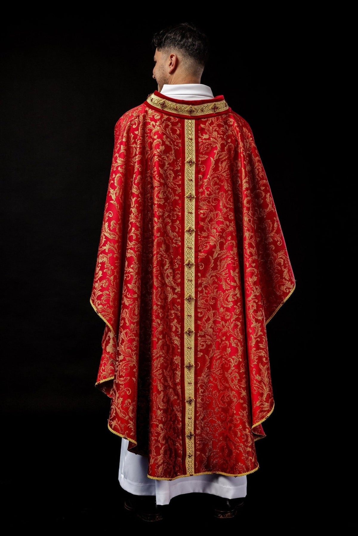 Handcrafted chasuble back view in red with gold floral jacquard and central orphrey