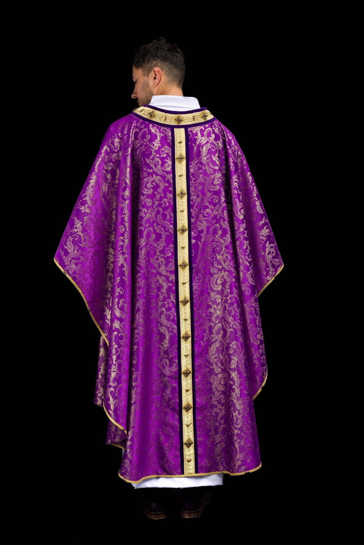 Handcrafted Catholic chasuble in purple with gold floral jacquard and central gold orphrey, back view