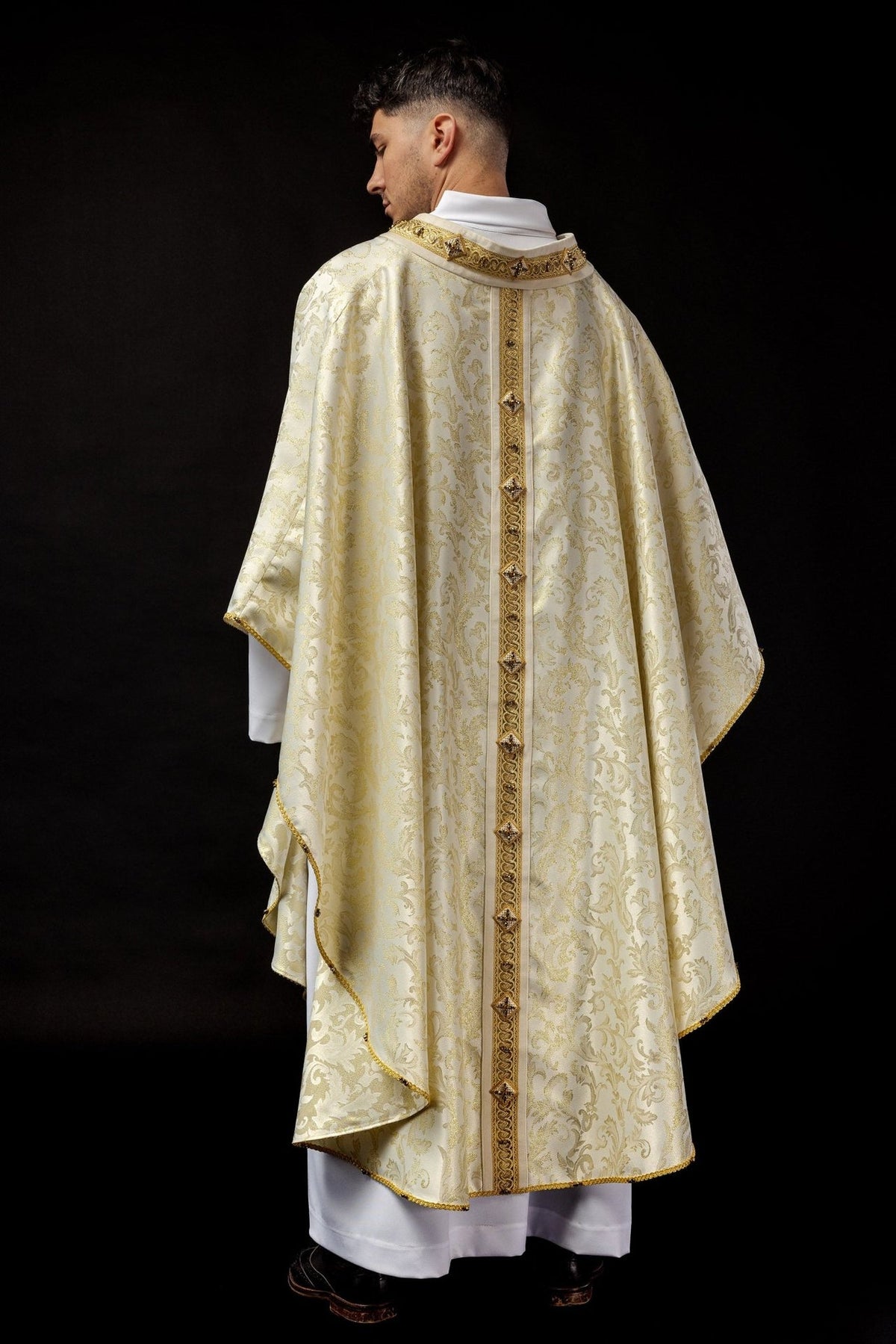 Chasuble back view with ecru jacquard fabric and gold embroidered orphrey