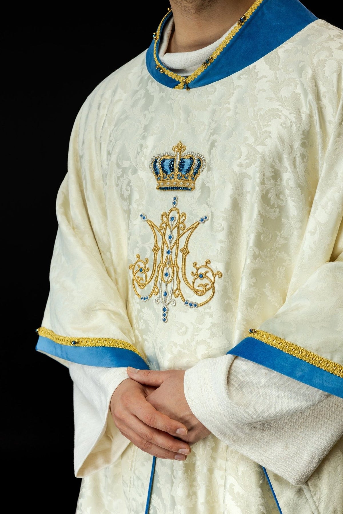 Marian chasuble close-up showing gold and blue Marian symbol embroidery