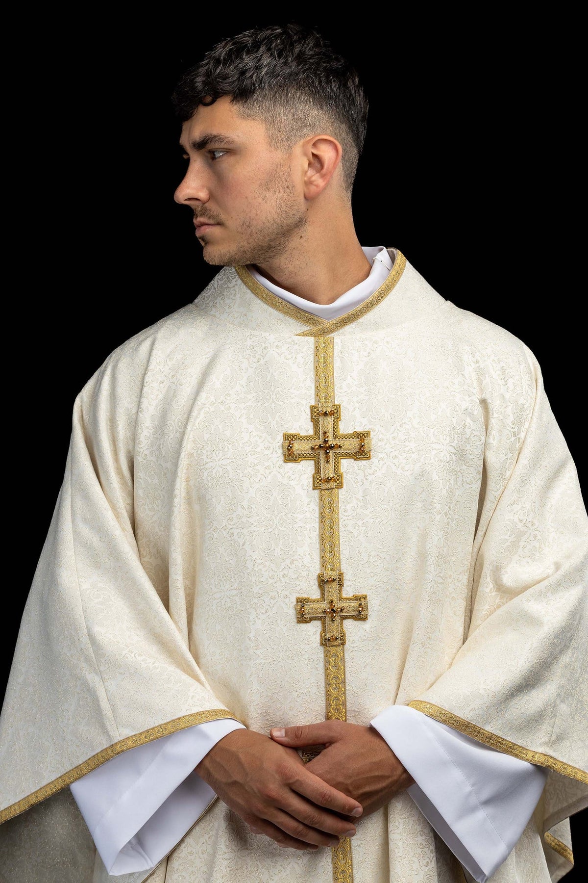 Handcrafted chasuble with natural stones, close-up of ivory brocade front and jeweled crosses