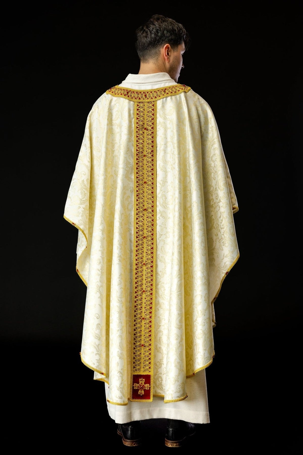 Handcrafted chasuble back view, ivory jacquard fabric with gold motifs, red orphrey and cross