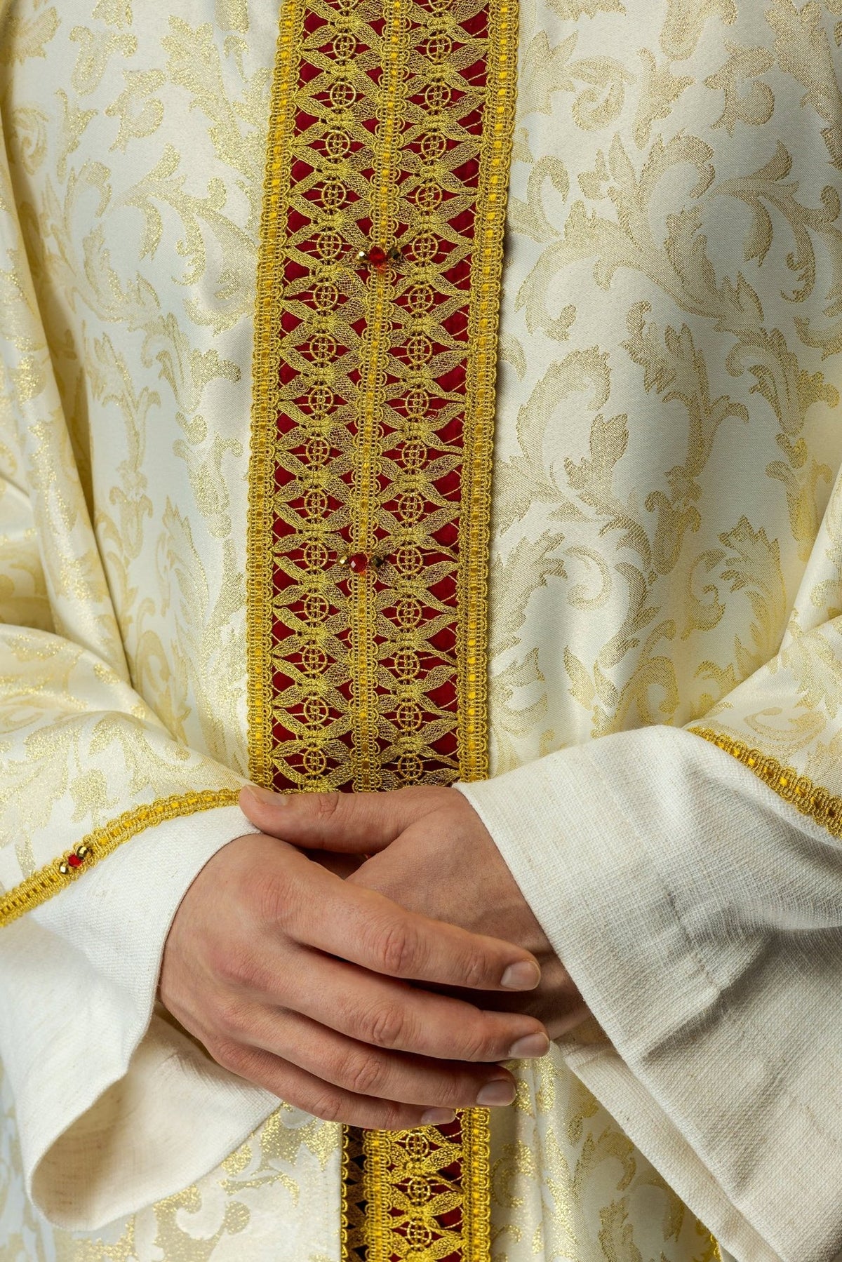 Handcrafted chasuble front close-up with red and gold orphrey, embroidery and natural stones