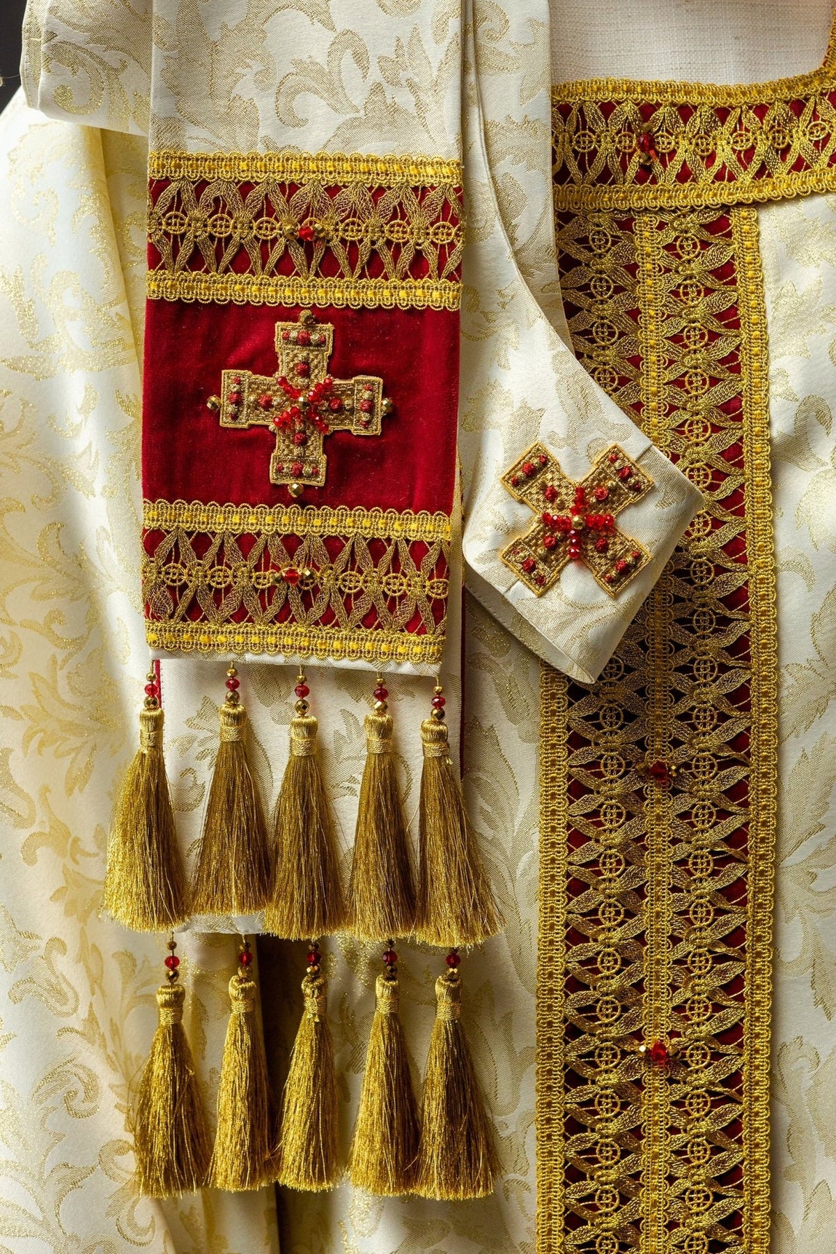Handcrafted chasuble and stole detail with gold embroidery, red velvet and tassels