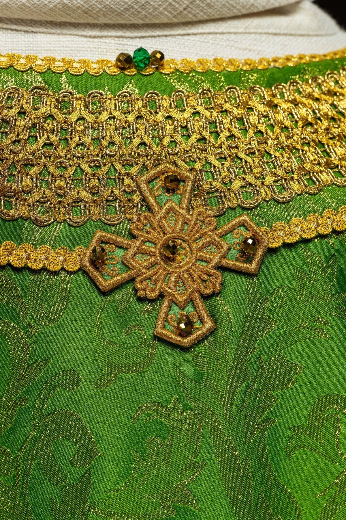 Handcrafted Green Chasuble detail with gold cross embroidery and natural stones