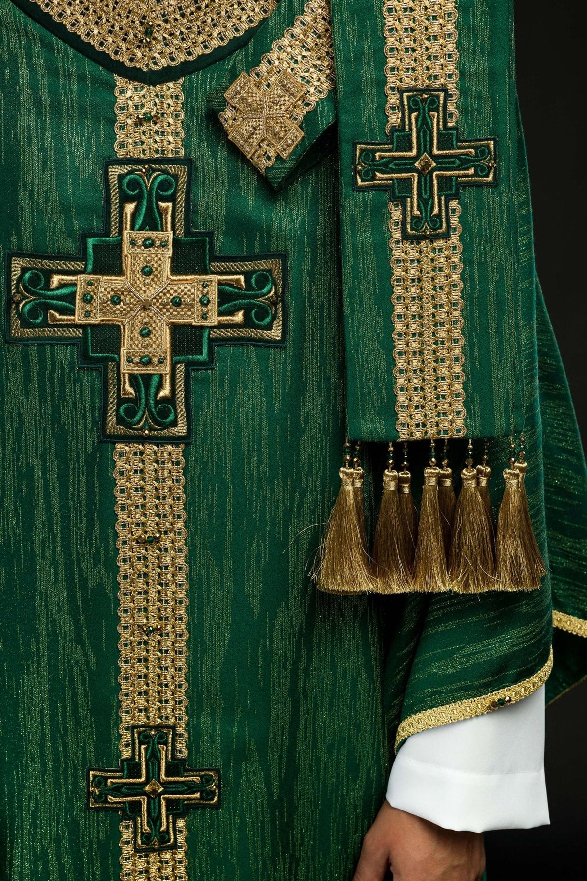 Green chasuble neckline close-up with gold embroidery and natural stones