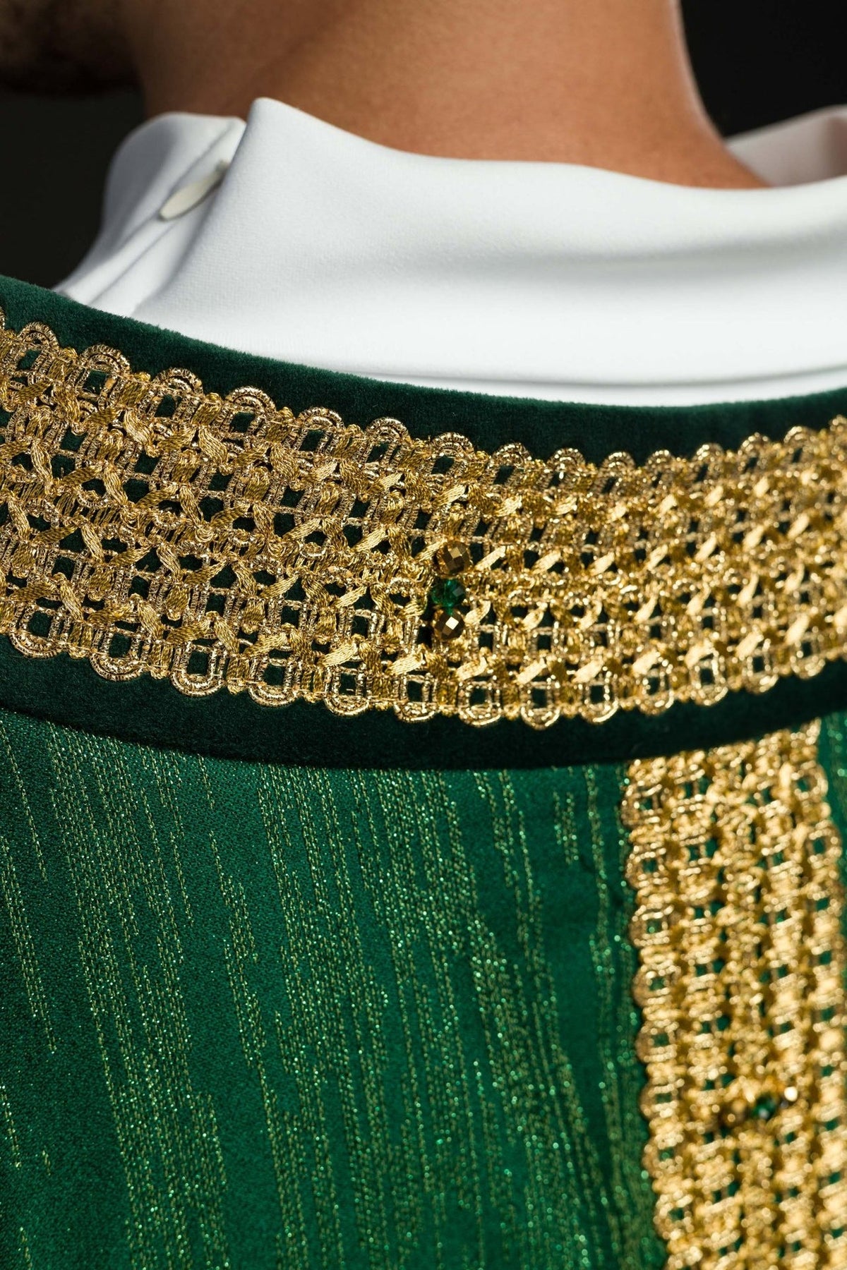 Green chasuble close-up of gold cross embroidery and fabric