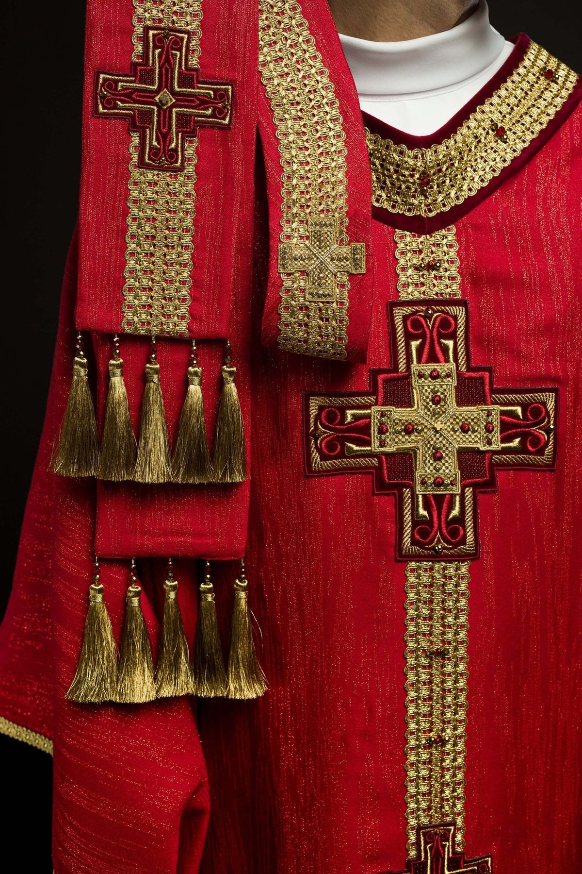Red chasuble with matching stole featuring gold cross embroidery and tassel