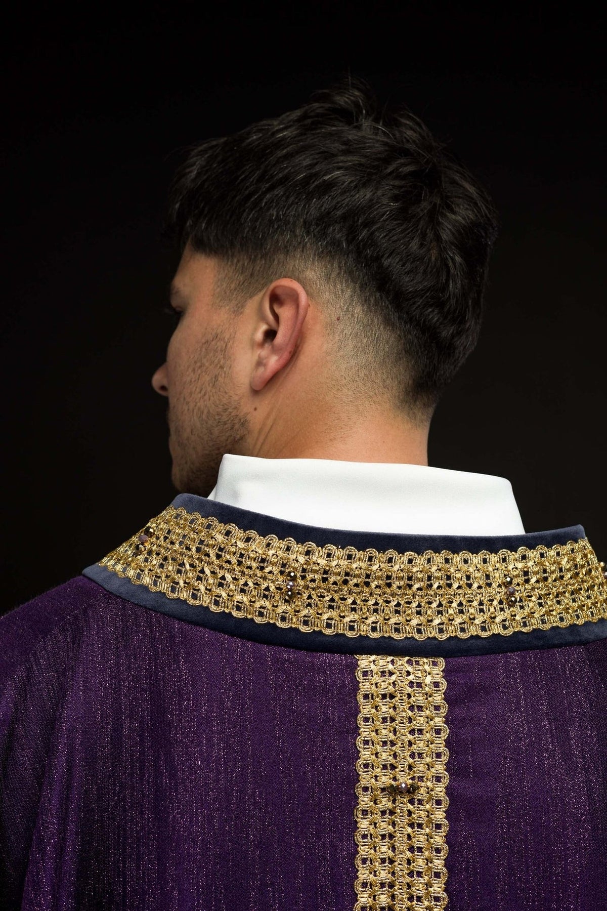 Purple chasuble back view with gold neckline and central trim