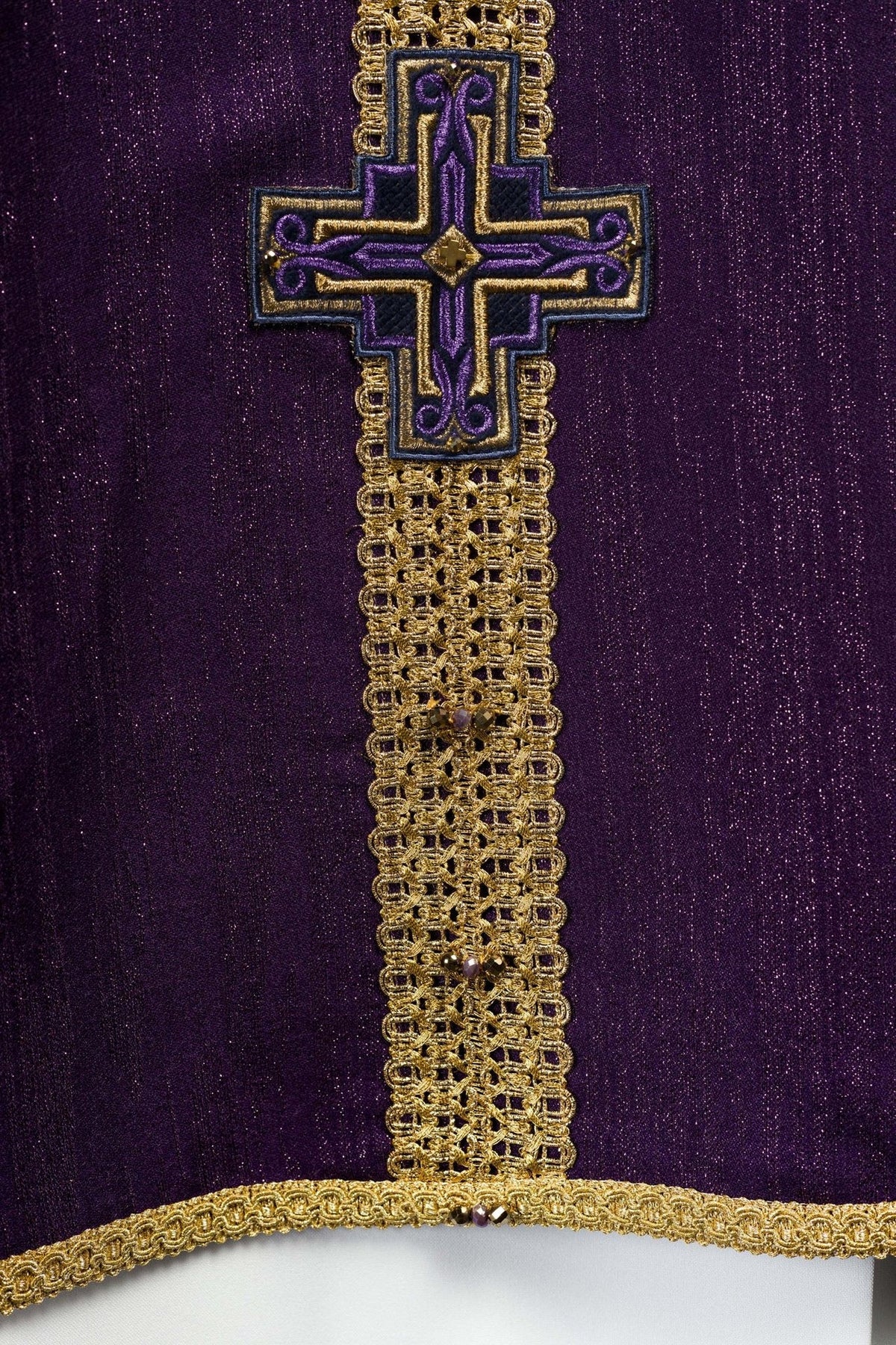 Purple chasuble close-up of lower cross embroidery and gold trim