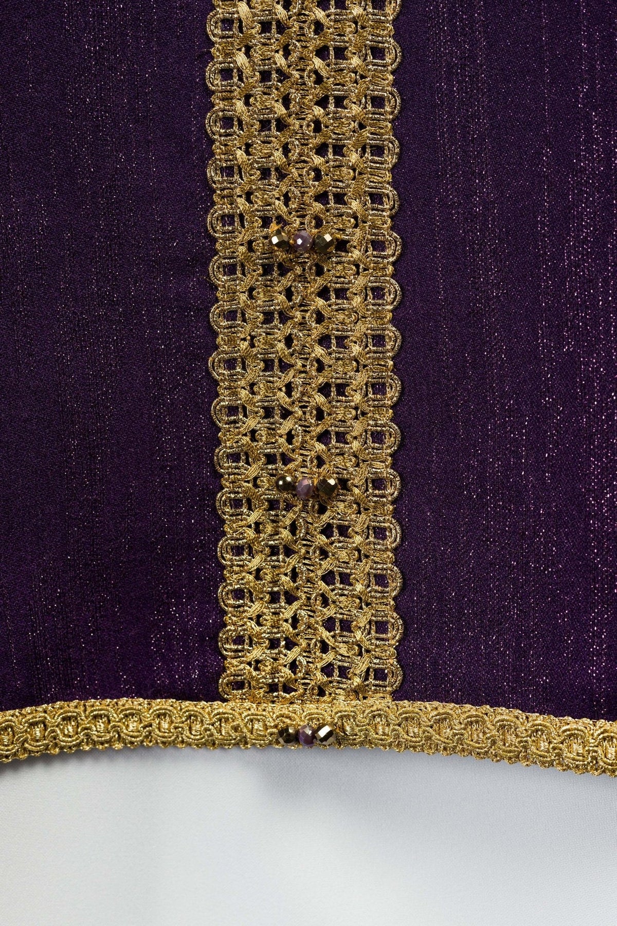 Purple chasuble close-up of central gold trim with natural stones