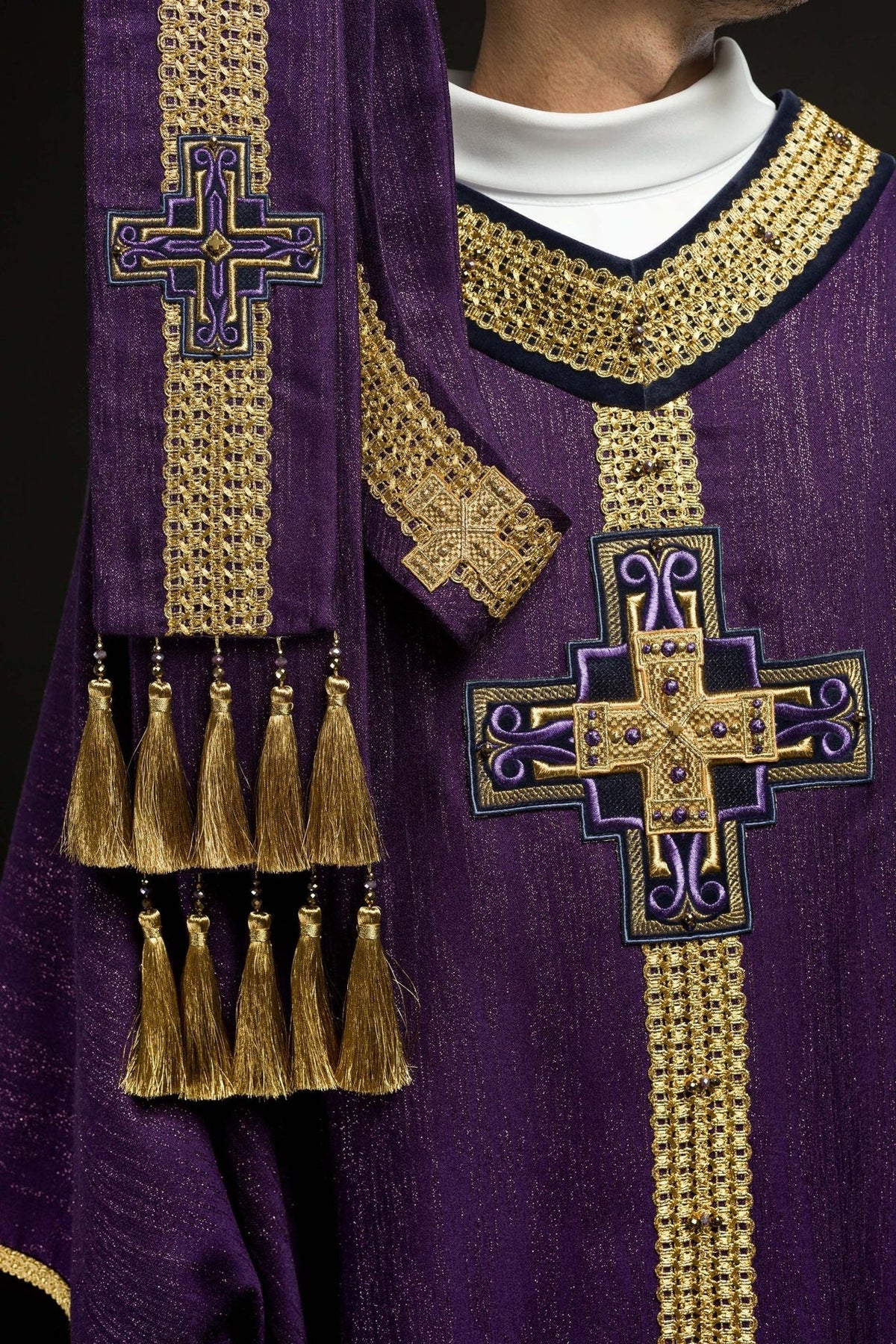 Purple chasuble close-up of gold neckline embroidery and cross