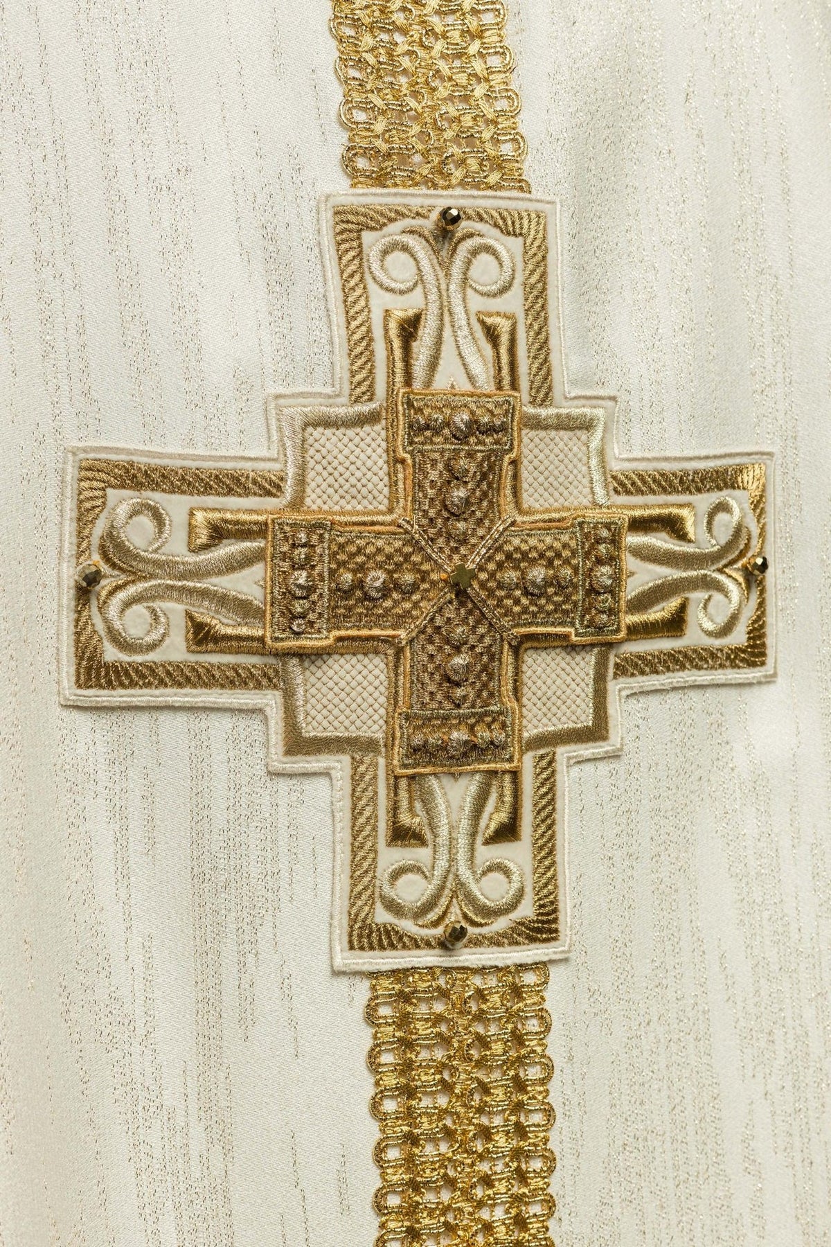 Chasuble close-up of ornate gold cross embroidery with natural stones
