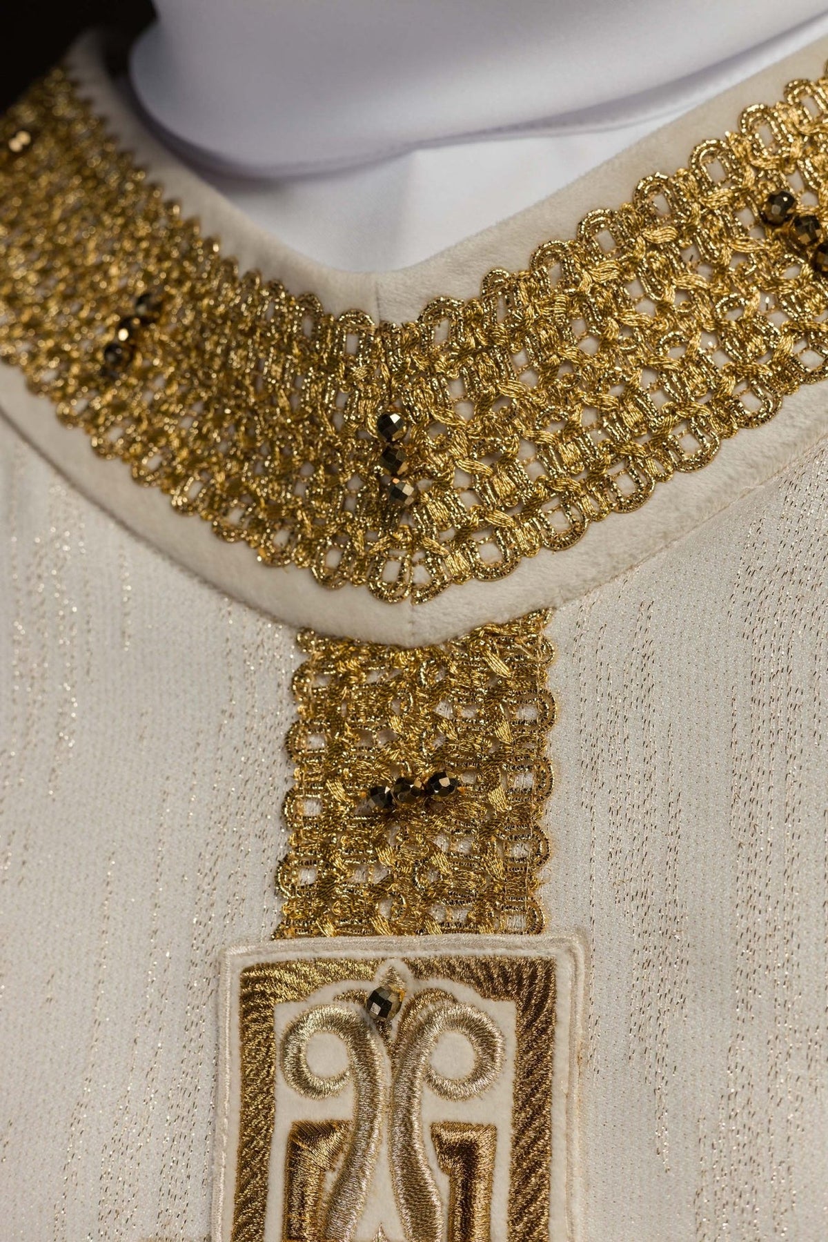 Chasuble close-up of gold collar embroidery with natural stones