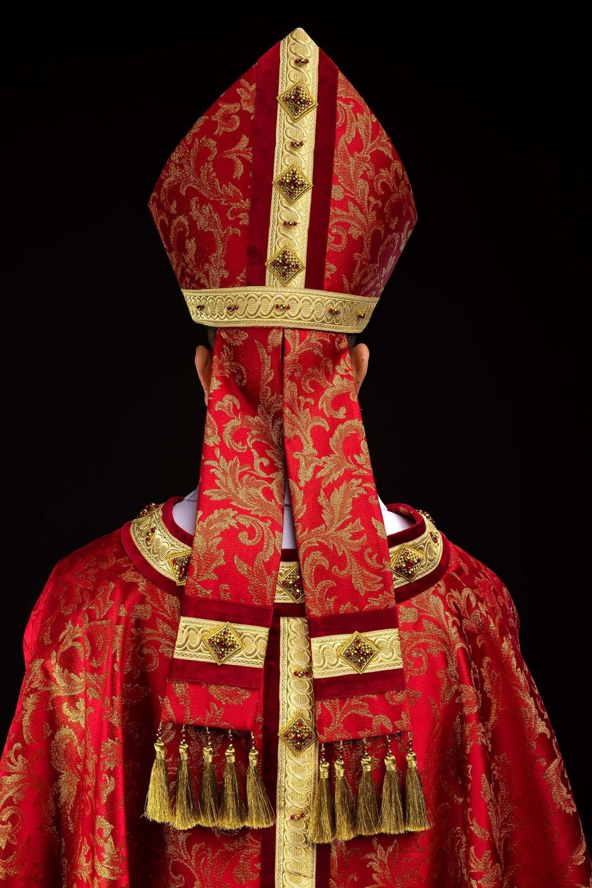 Red and gold miter back view with patterned fabric and embroidered band