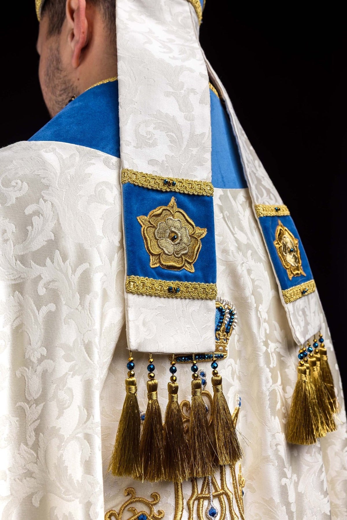Marian miter in three-quarter back view with ecru fabric and blue-and-gold details
