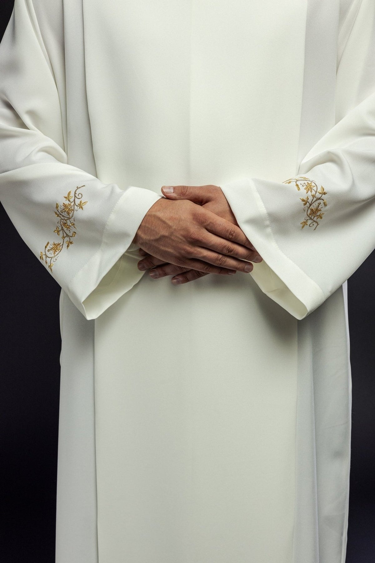 Ecru alb front close-up showing gold embroidered sleeve motifs