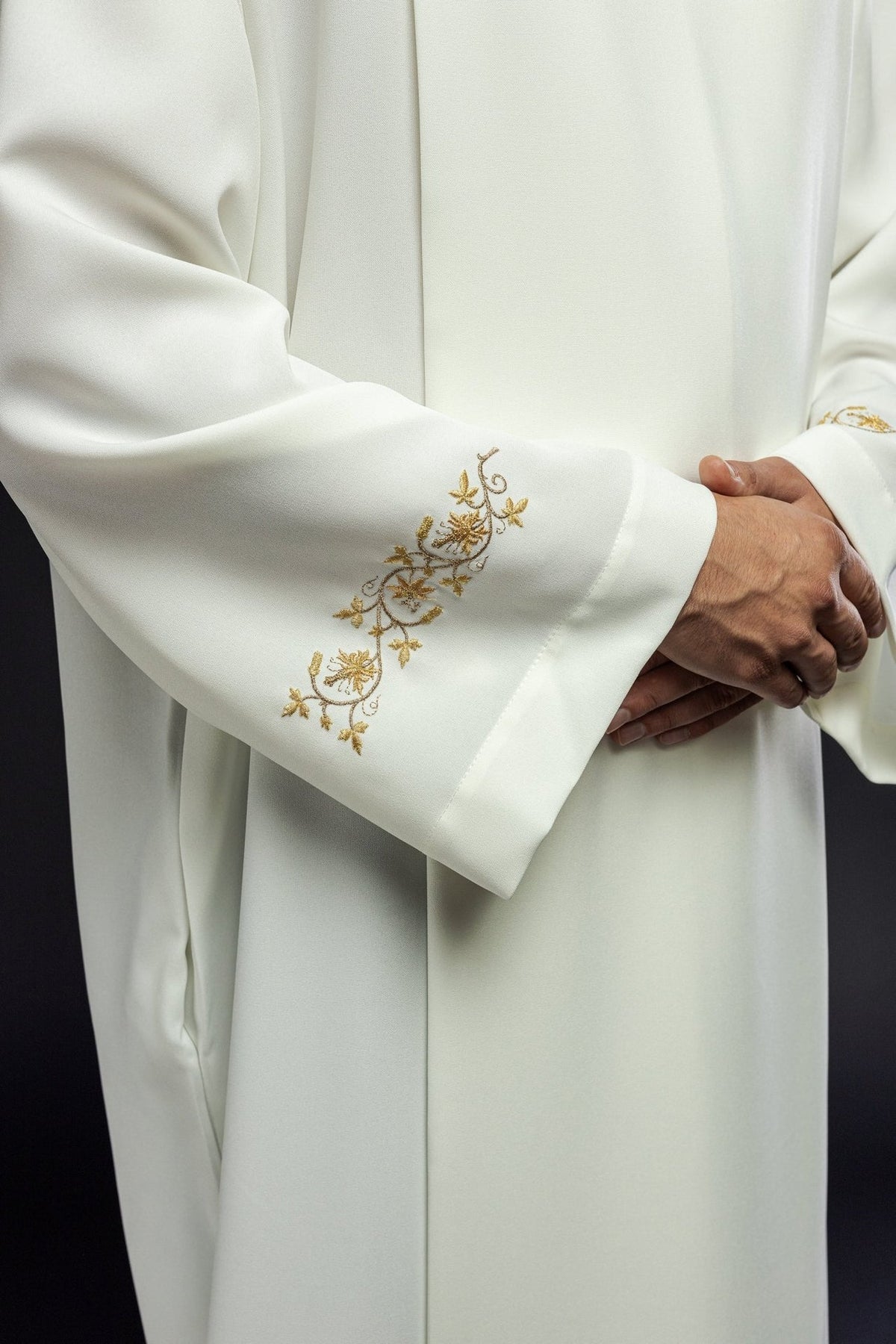 Ecru alb sleeve close-up with gold floral embroidery