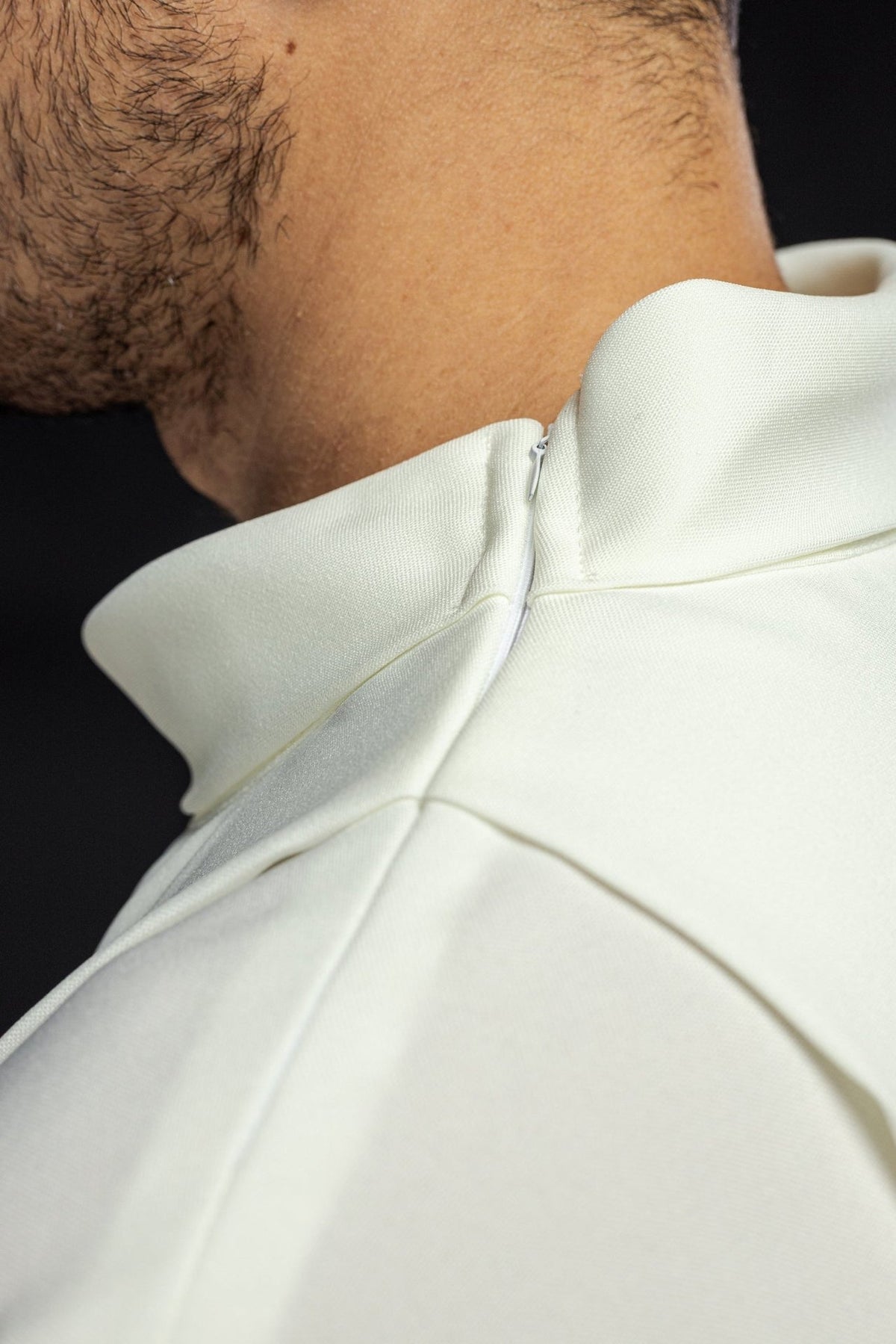 Ecru alb close-up showing the stand-up collar and back fastening