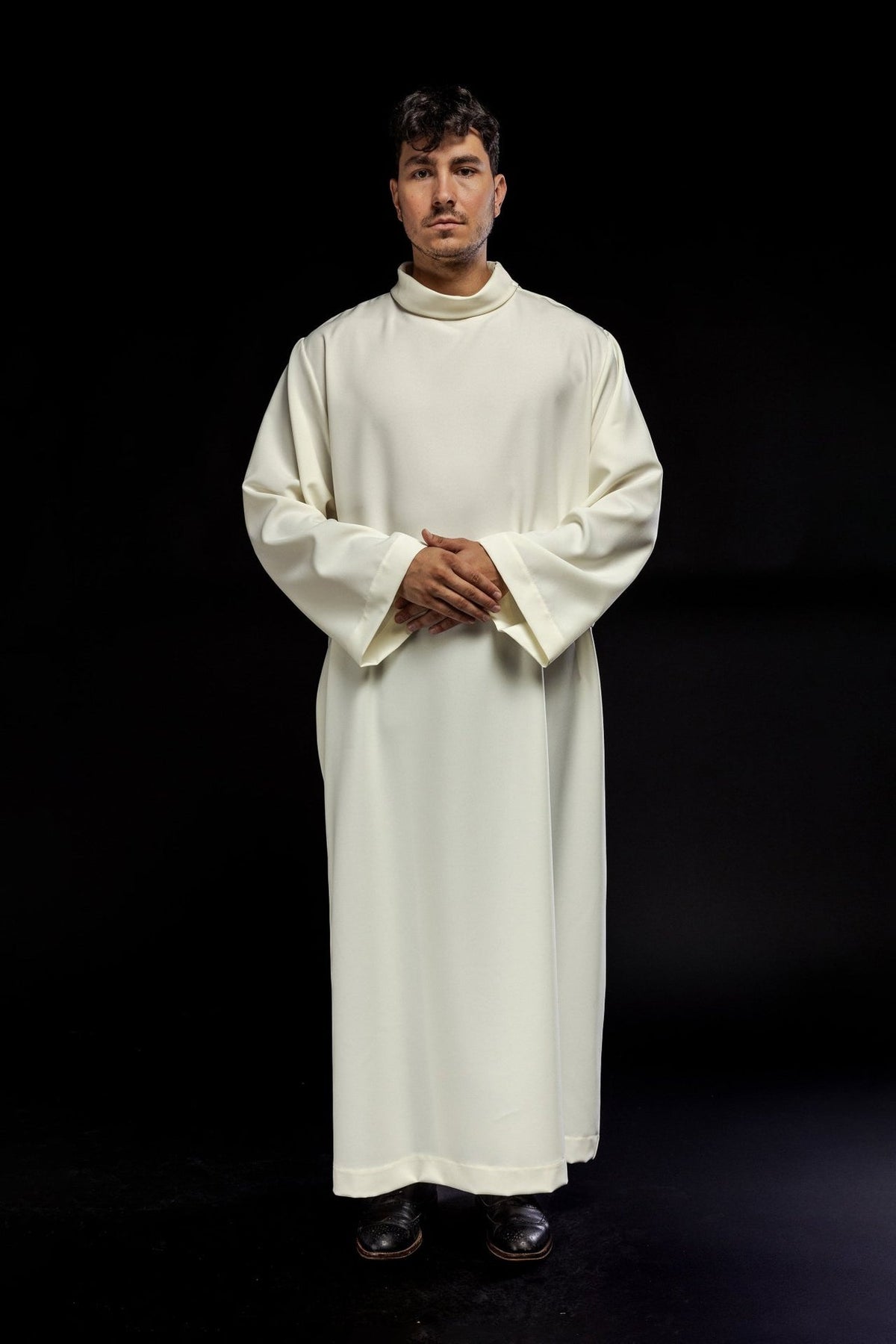 Ecru priest alb worn from the front, showing wide cuffs and high collar