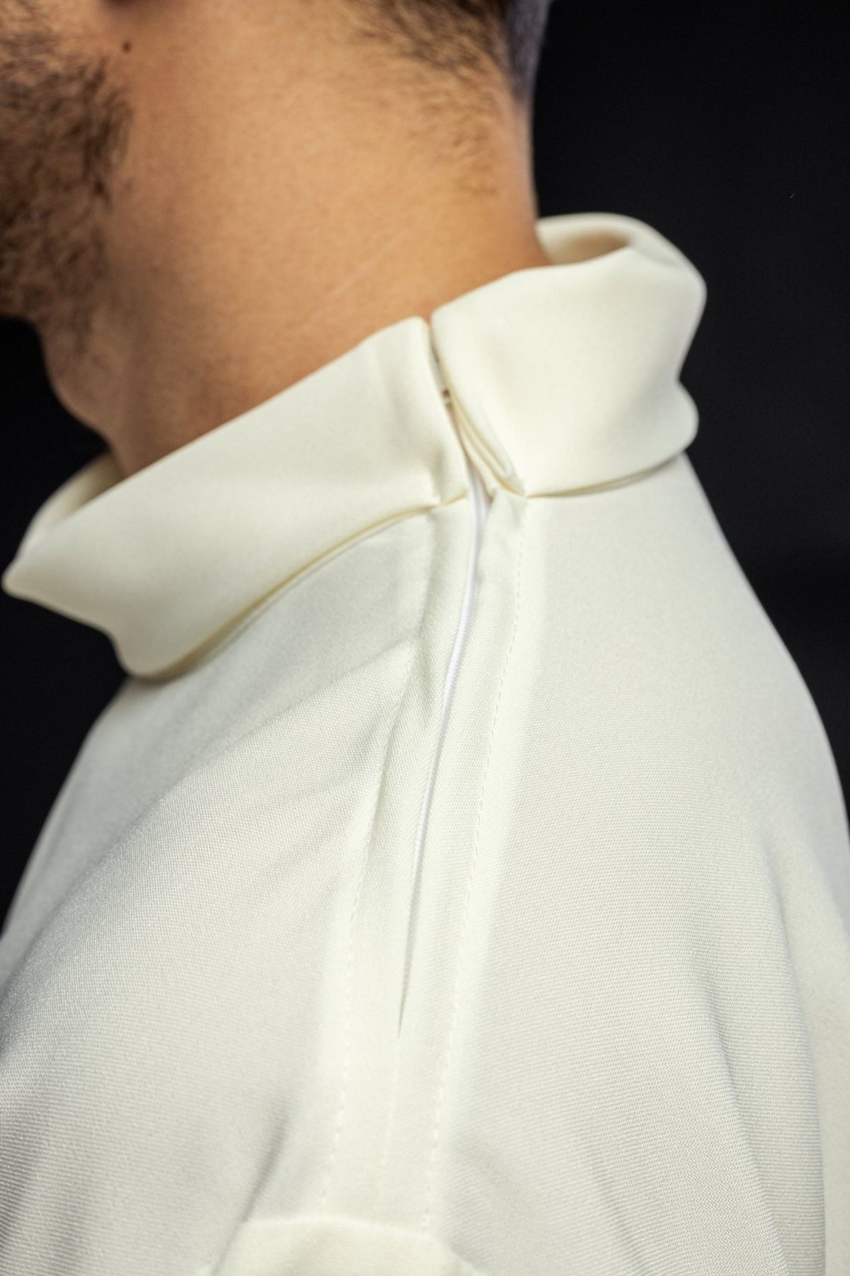 Ecru alb collar close-up, showing the back fastening and fabric texture