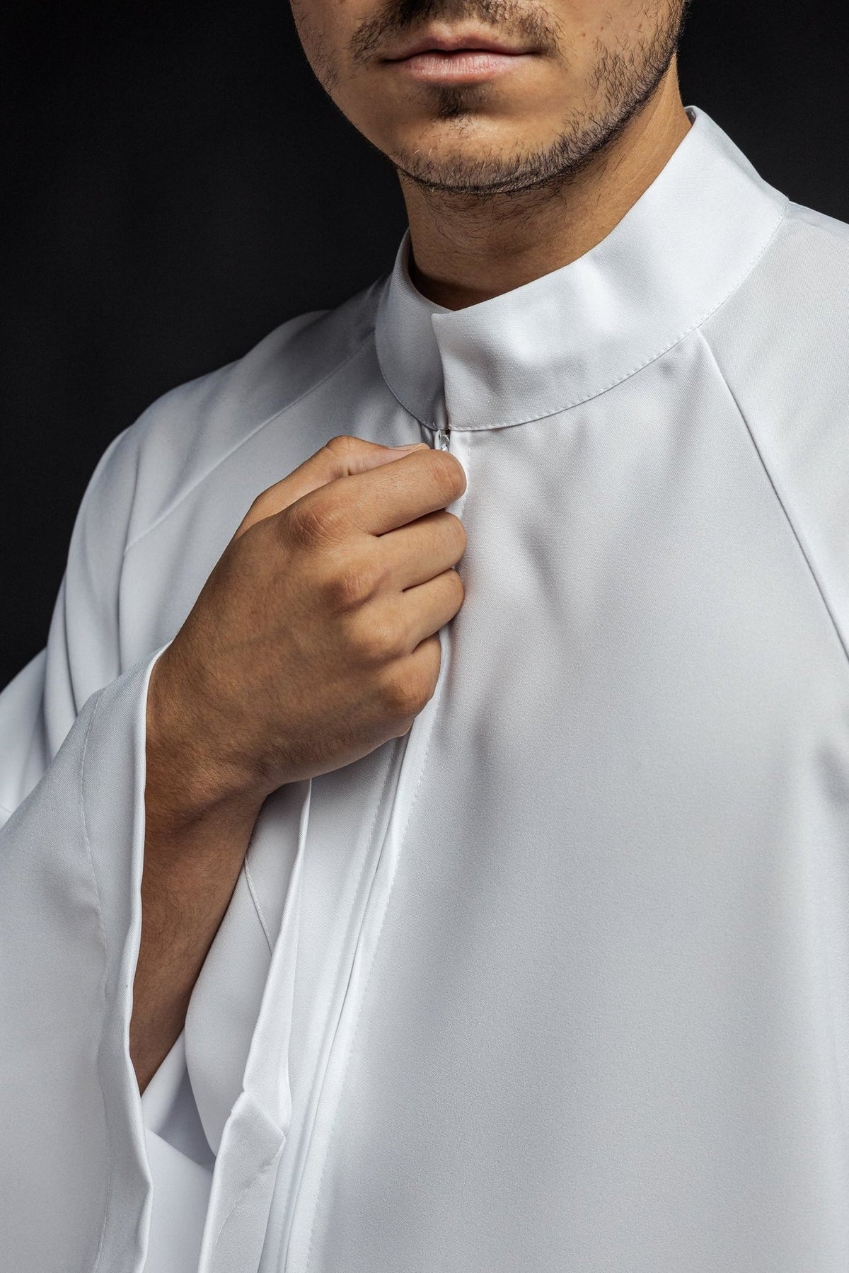 White priest alb detail showing the collar, zipper and smooth fabric