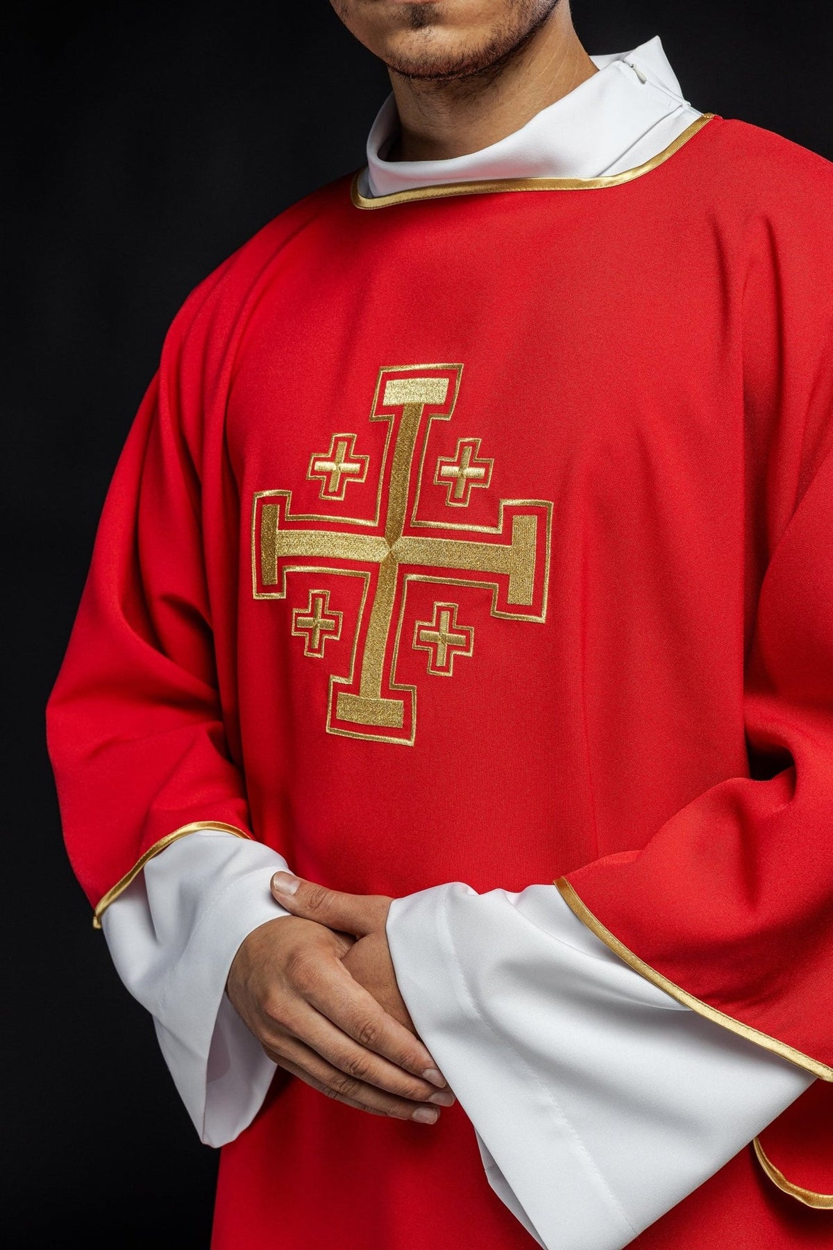 Red dalmatic close-up of embroidered gold cross and trim