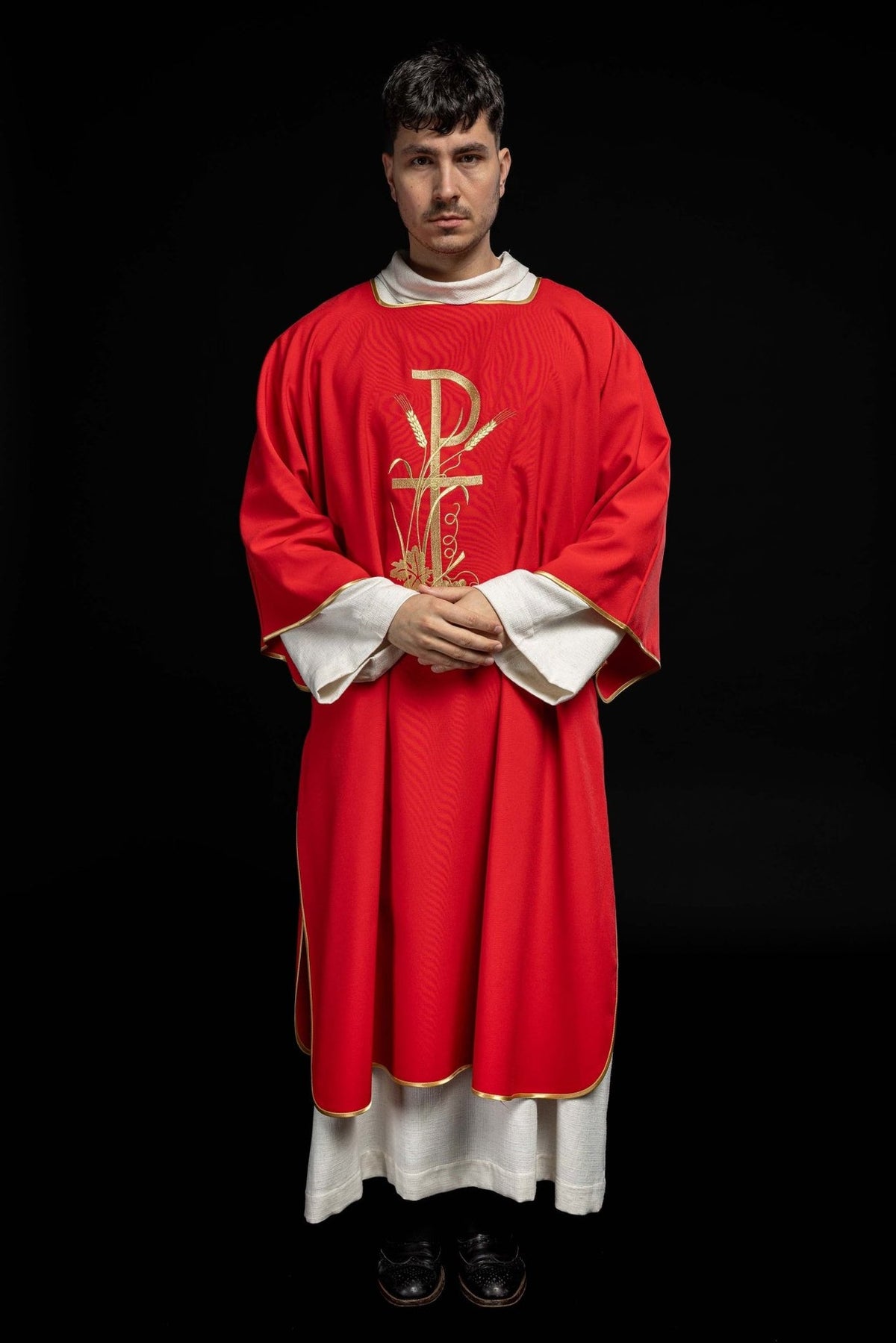 Red dalmatic front view showing wide sleeves, gold trim and central embroidery
