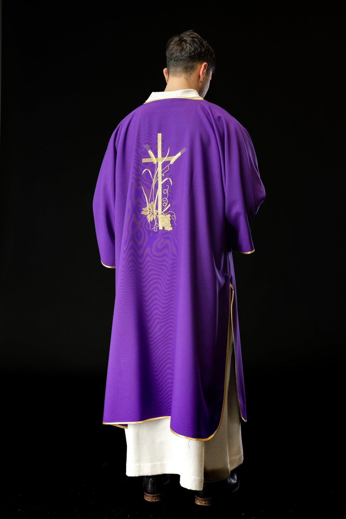Purple dalmatic shown from the back and side with gold trim and cross embroidery