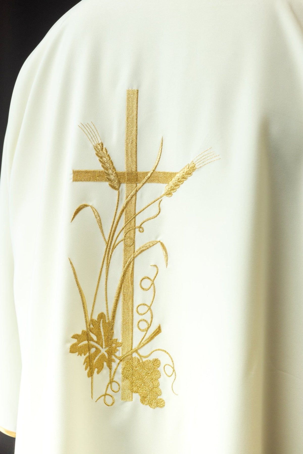 Ecru dalmatic front detail showing gold cross, wheat, vines and grape embroidery