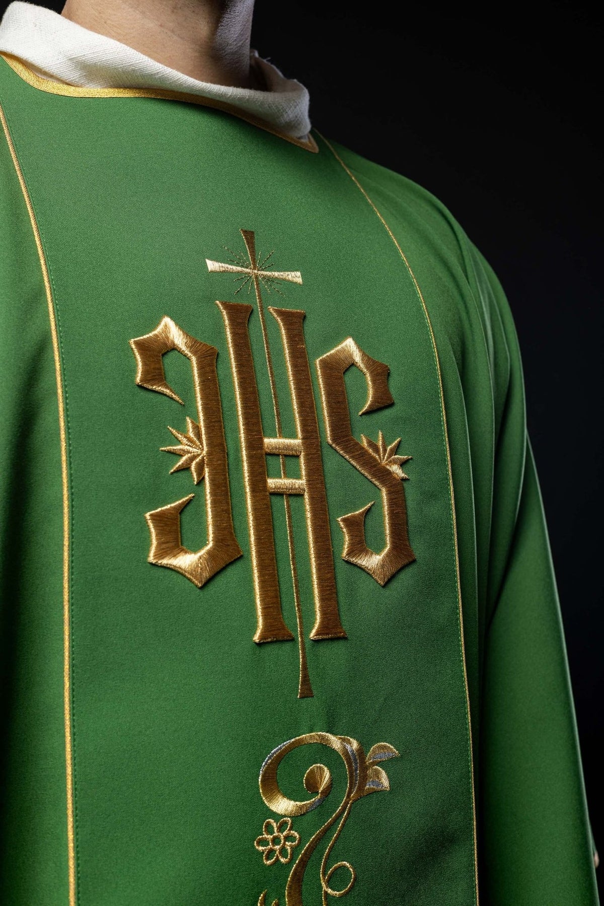 Green dalmatic close-up showing gold IHS embroidery and trim