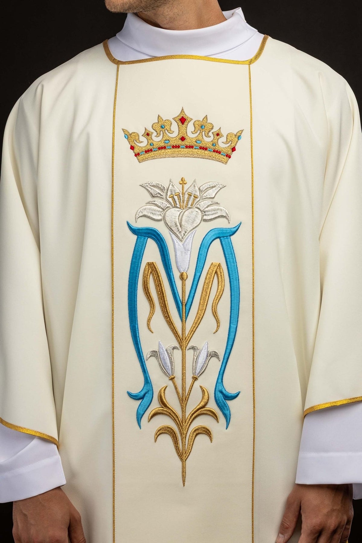 Ecru dalmatic front close-up showing crown and Marian symbol embroidery