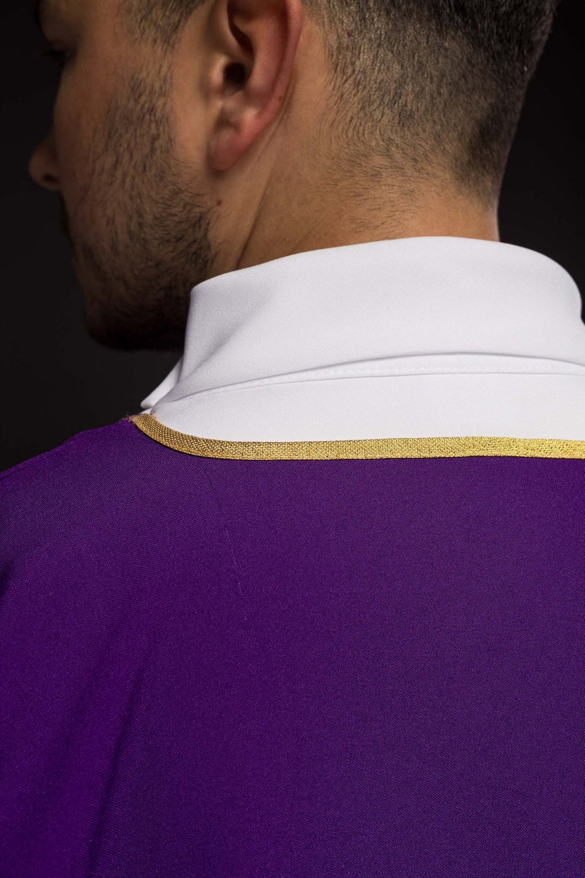 Purple dalmatic close-up of white back collar and gold shoulder trim