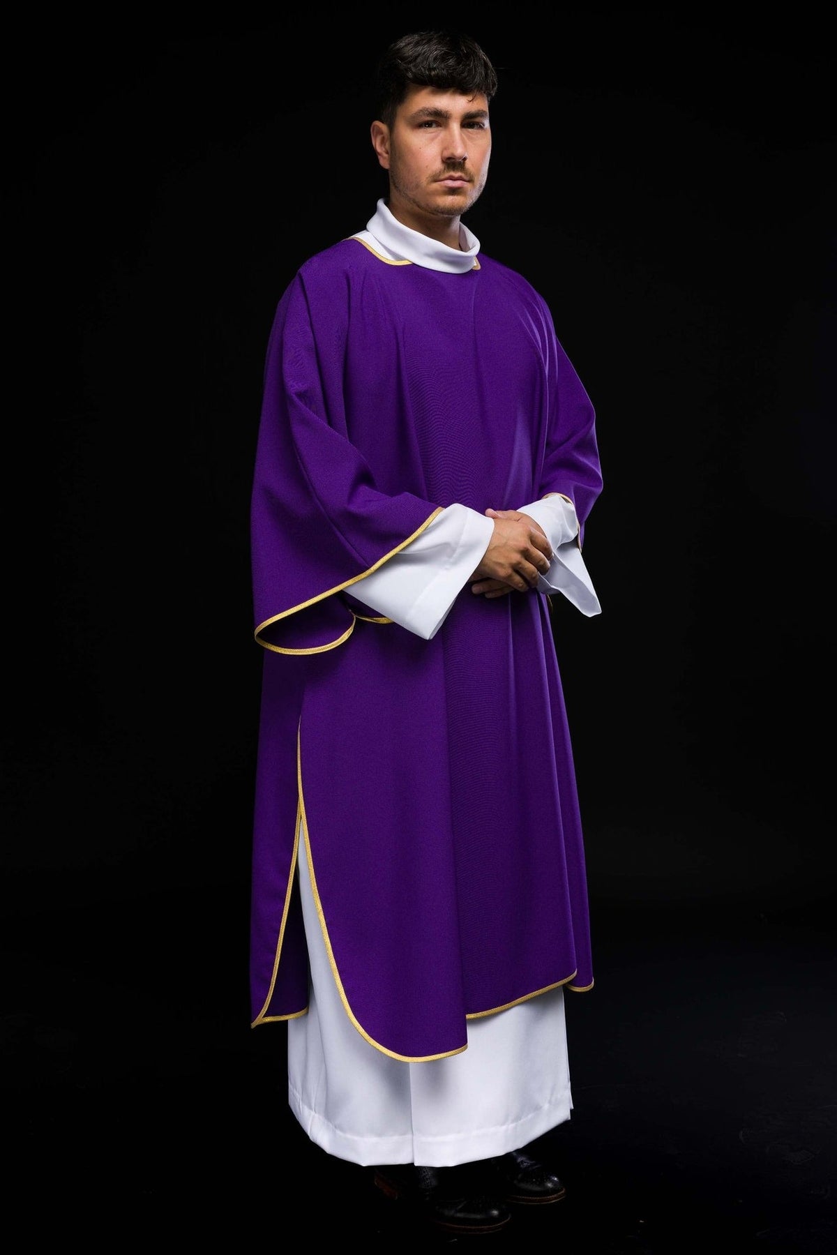 Purple dalmatic close-up showing gold sleeve trim and white cuffs