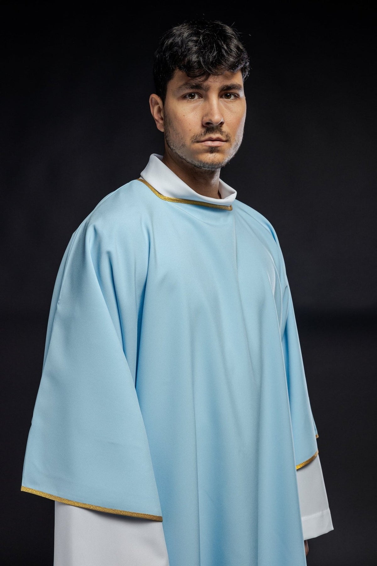 Blue dalmatic, close front view showing smooth fabric and gold-trimmed collar