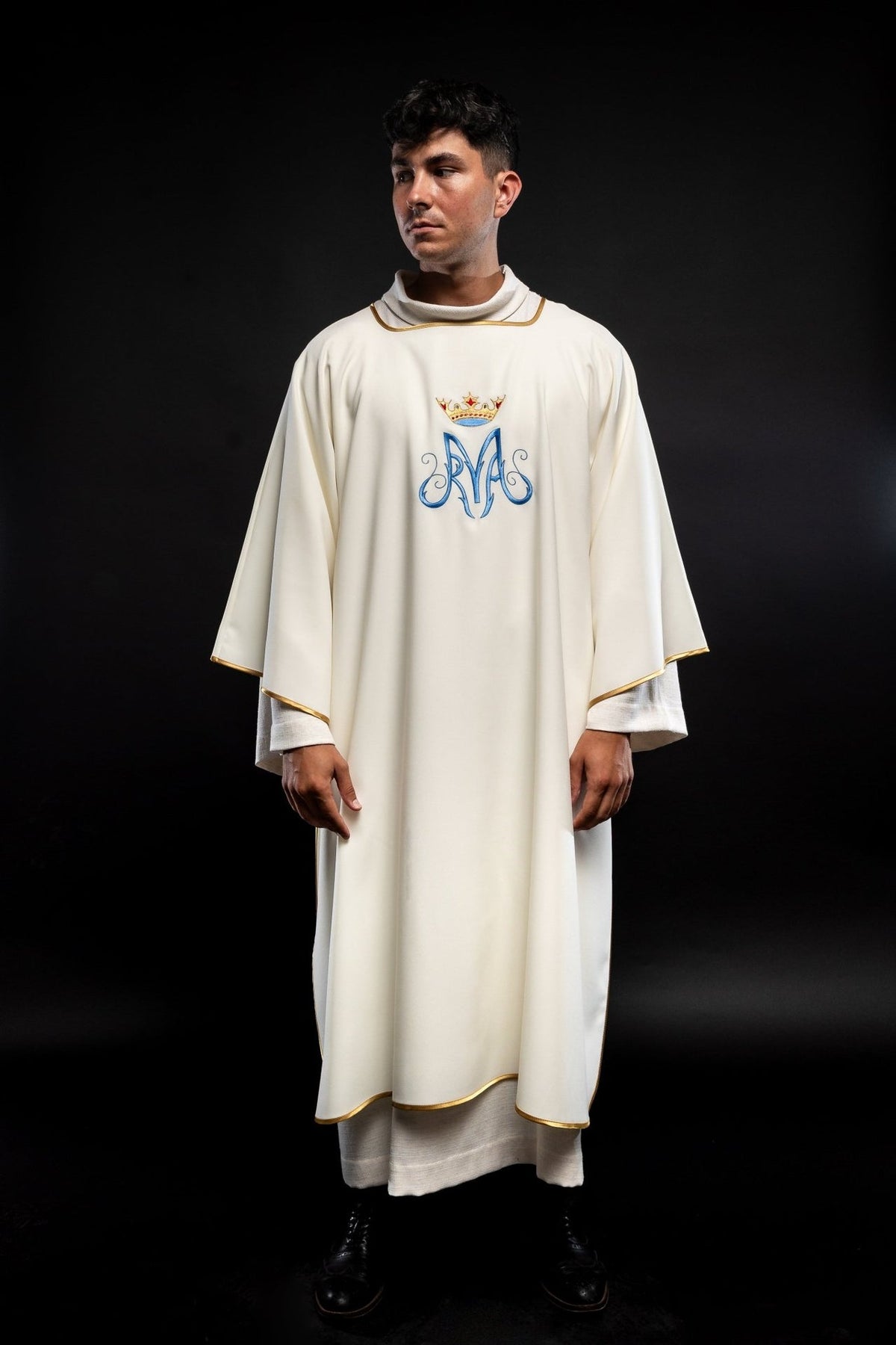 Dalmatic front view showing white satin fabric, gold trim and crowned Marian embroidery