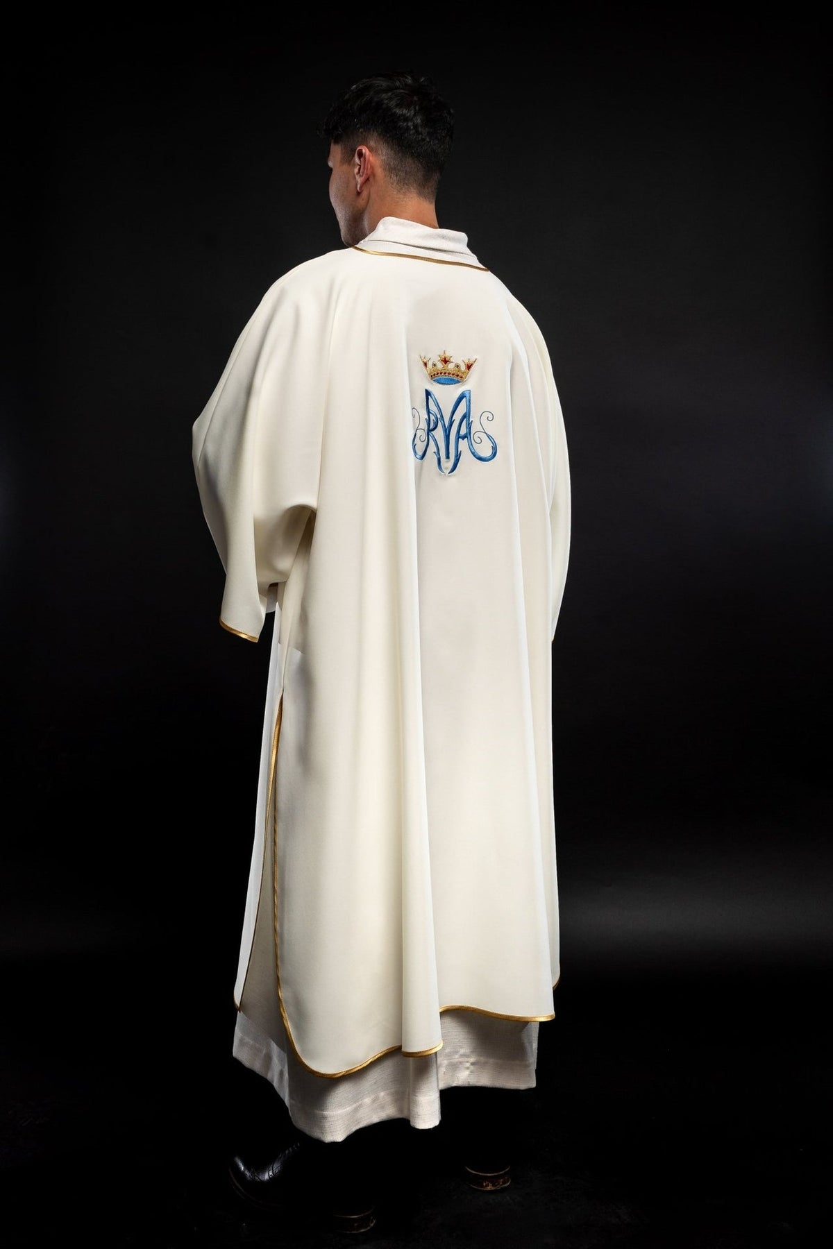 Dalmatic back view in white with gold trim and Marian embroidery
