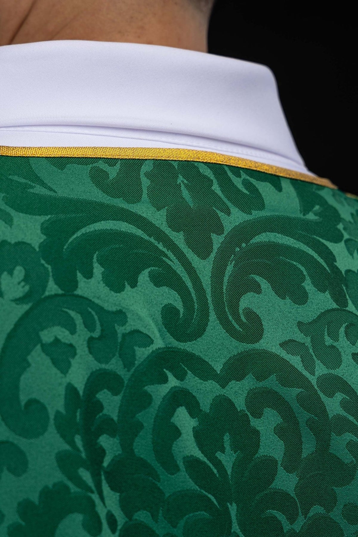 Green dalmatic close-up of patterned jacquard fabric and gold trim