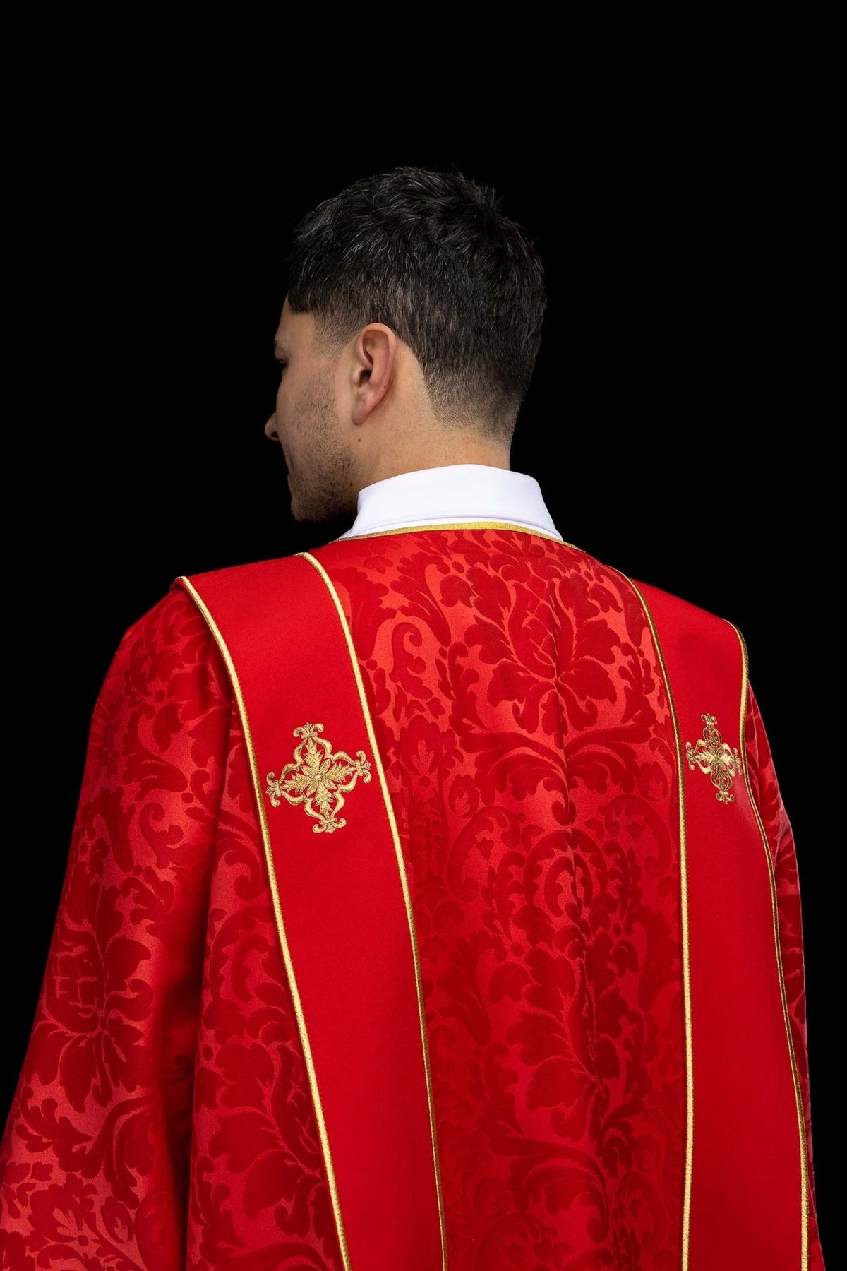 Red dalmatic back view with gold orphreys and embroidered crosses