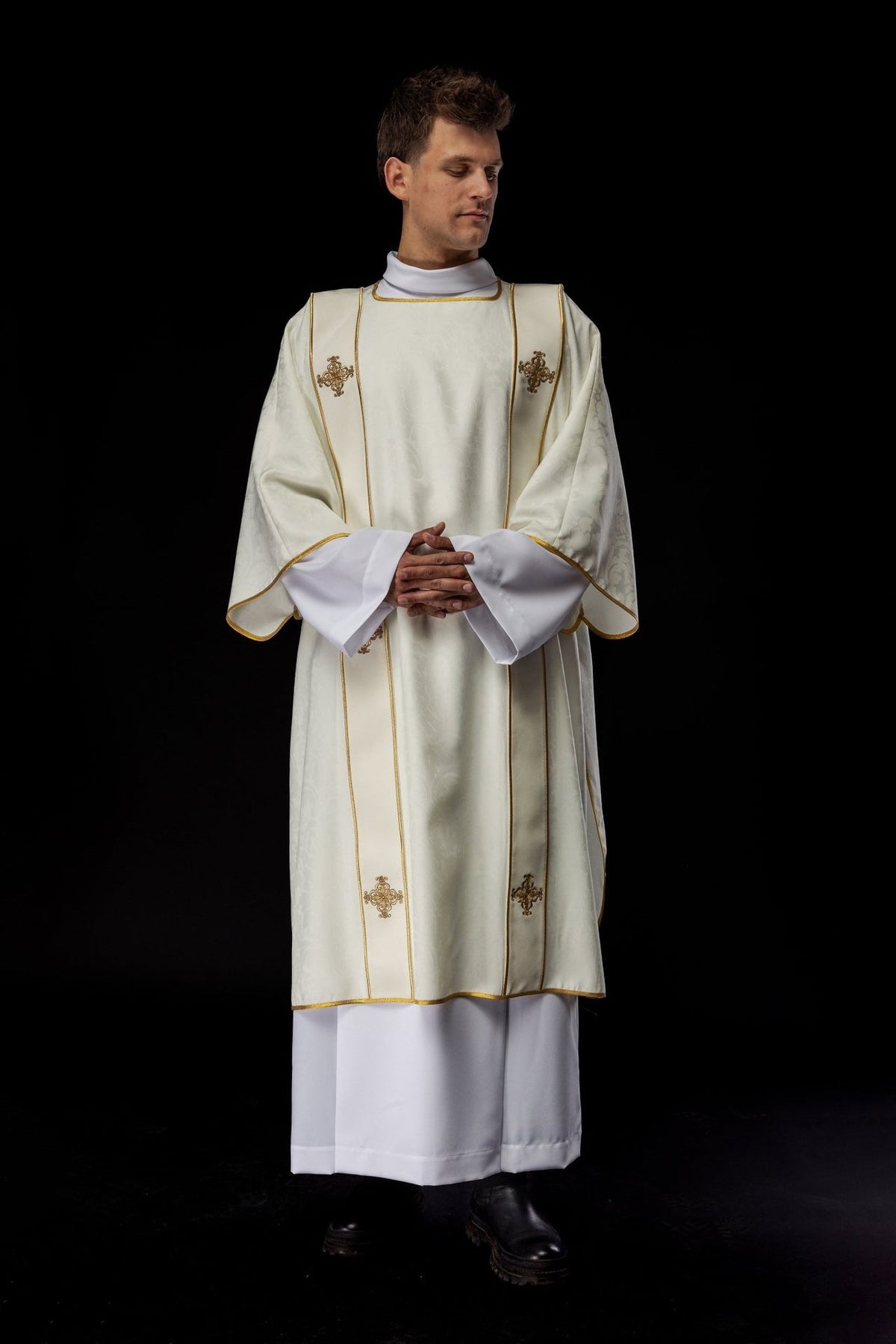 Ecru dalmatic front view with gold trim and embroidered crosses