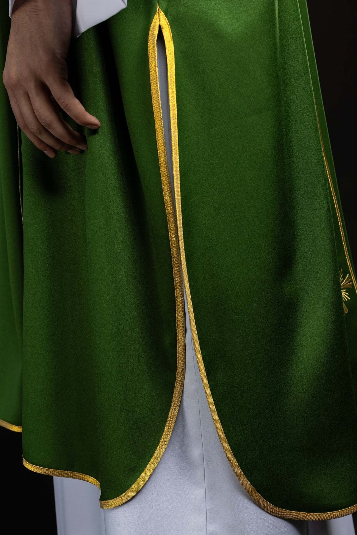 Green dalmatic side view showing gold-trimmed opening