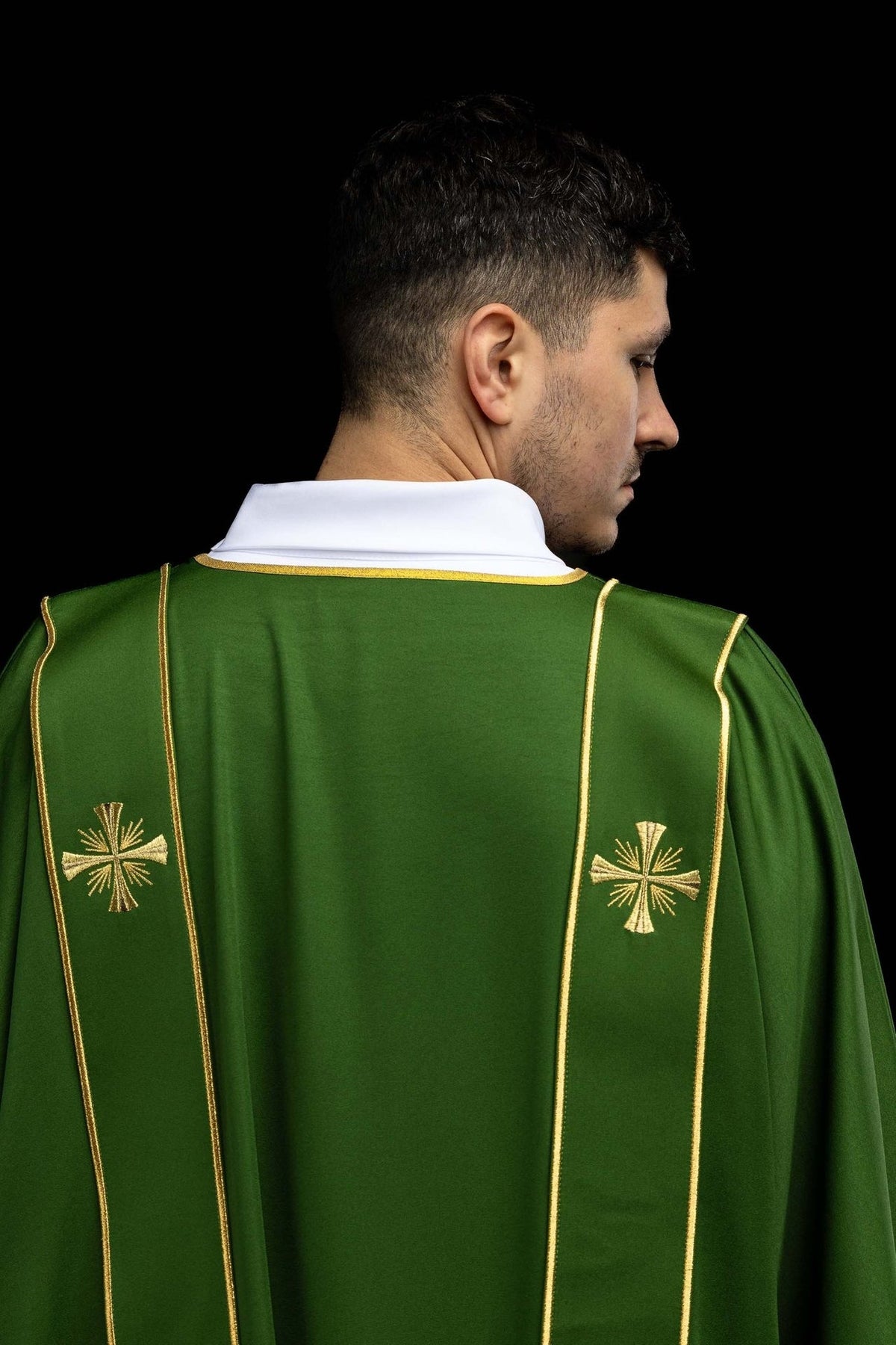 Green dalmatic back view with embroidered gold crosses