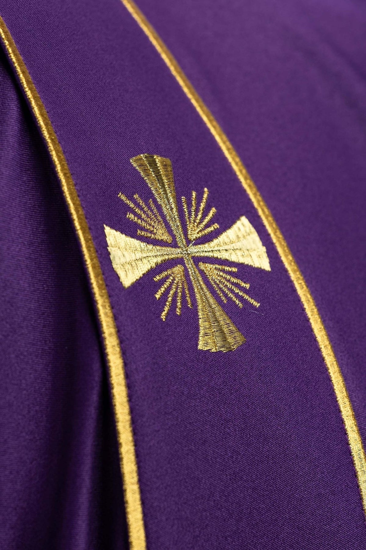 Purple stole with close-up of gold cross embroidery and gold trim