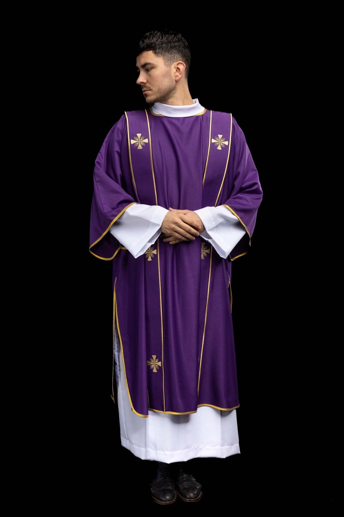 Purple dalmatic worn from the front with gold cross embroidery