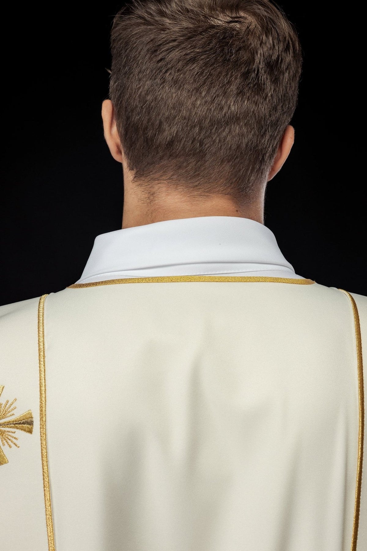 Ecru dalmatic side detail with gold orphrey and cross embroidery