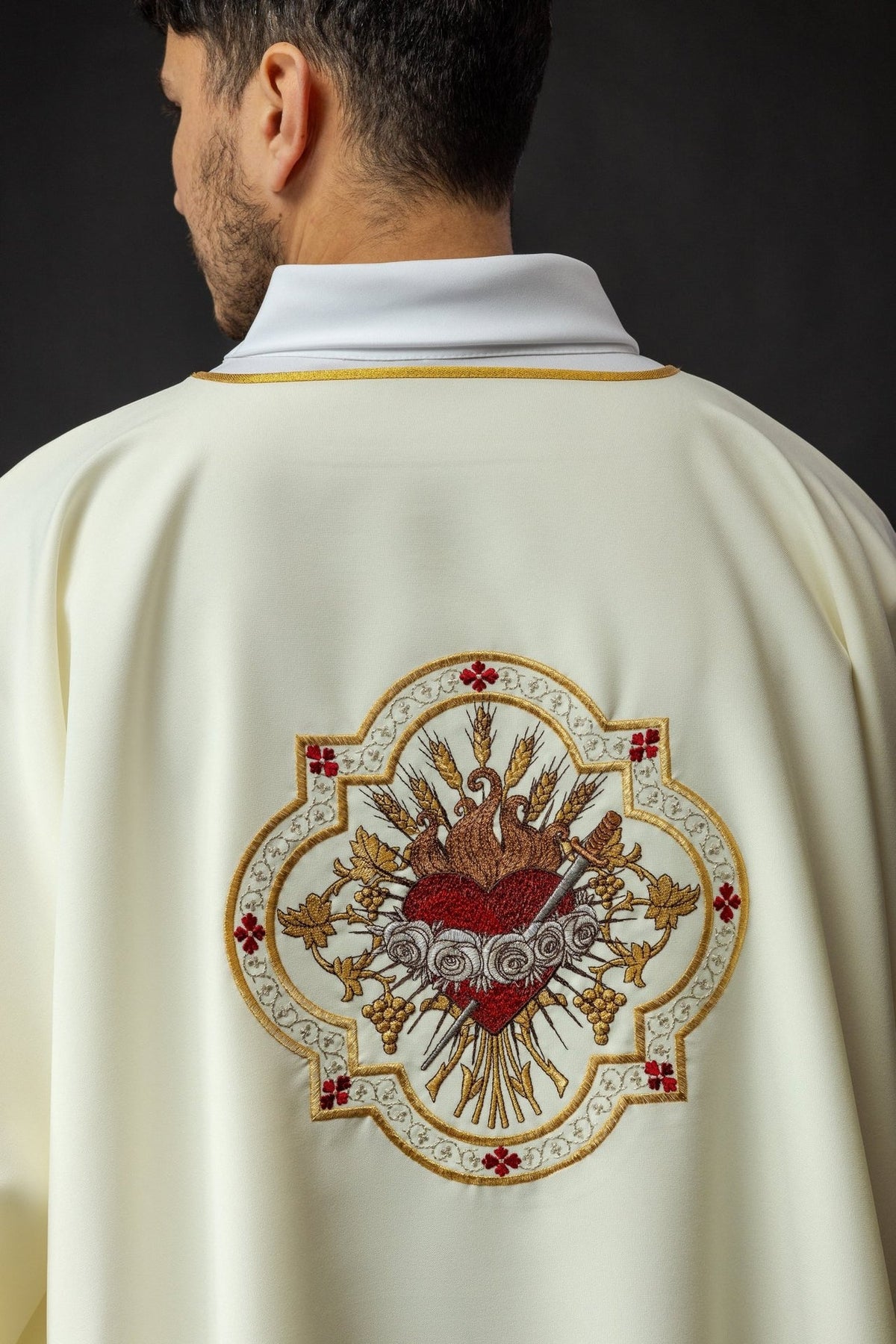 Dalmatic back close-up with gold collar trim and Heart of Mary embroidery