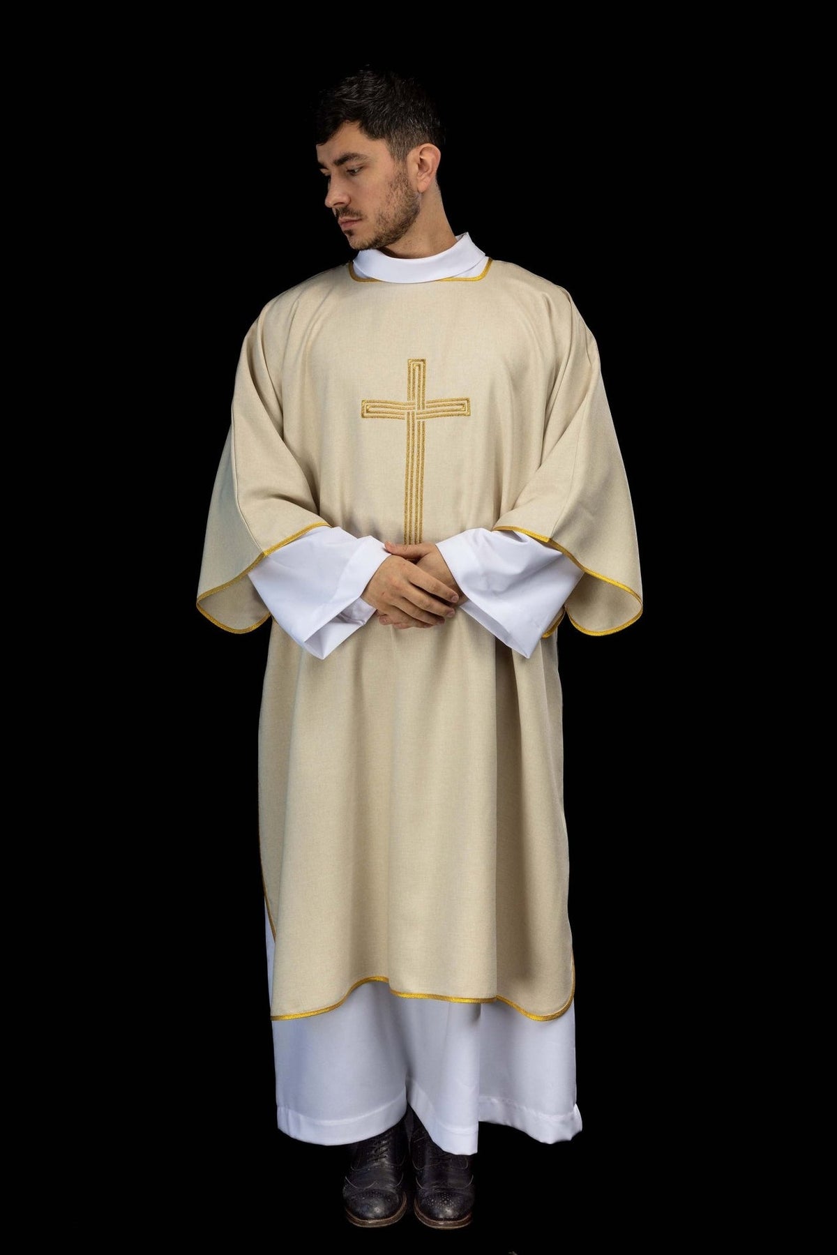 Ecru dalmatic worn from the front with embroidered gold cross
